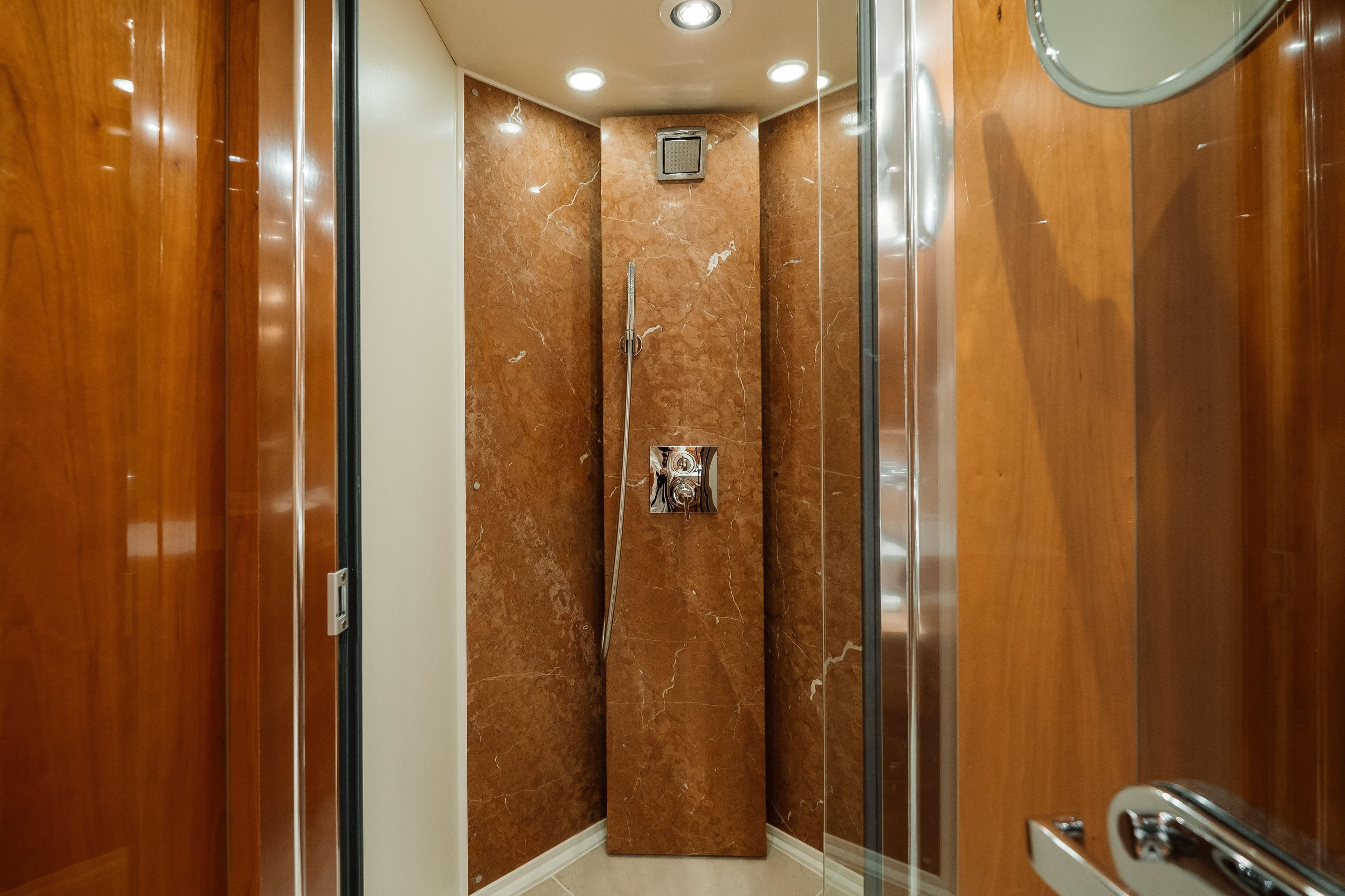 Luxurious shower area on a 2009 Sunseeker 30 Metre Yacht with elegant wood paneling.