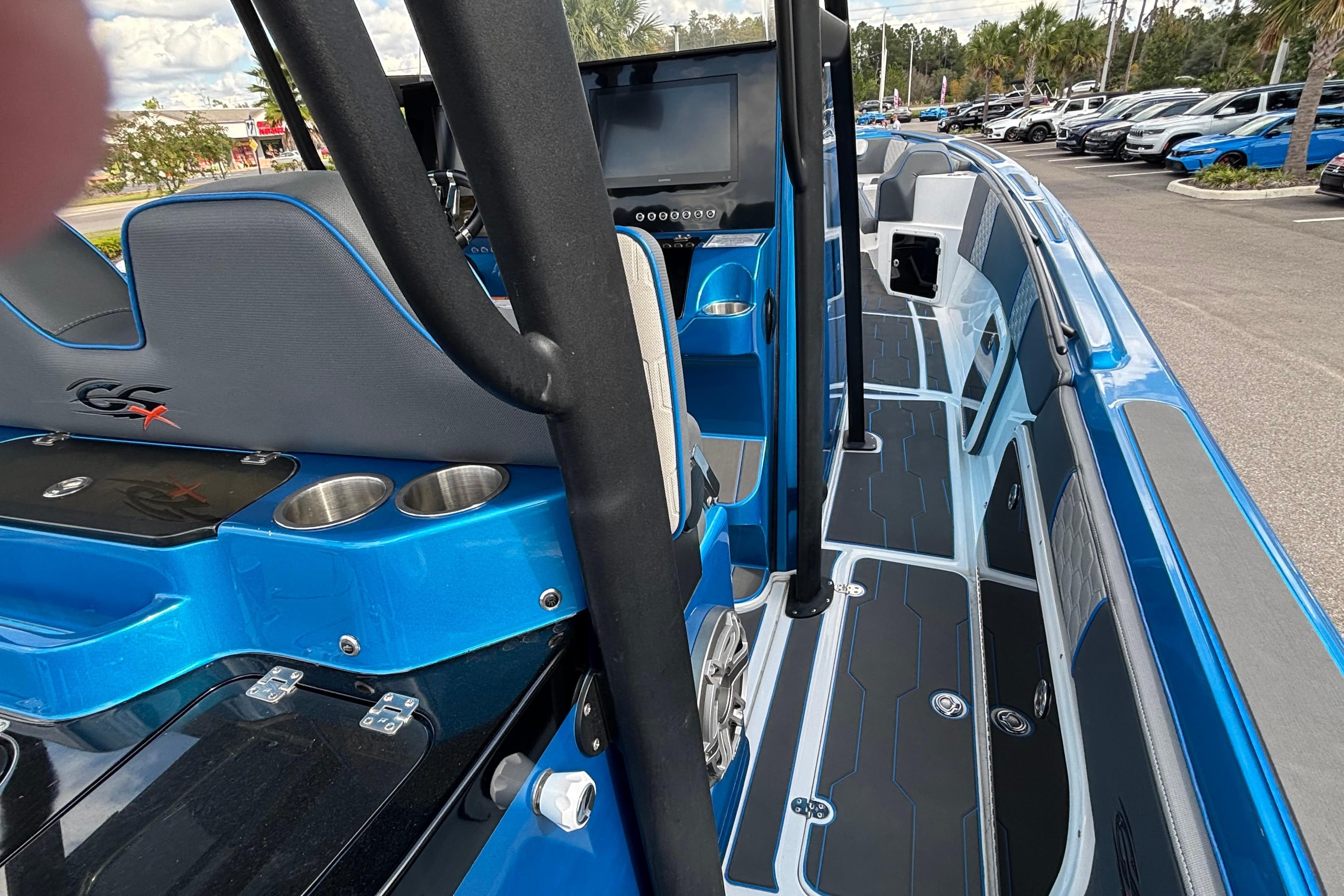 2024 GSX 36 boat interior with blue accents, modern seating, and cup holders.