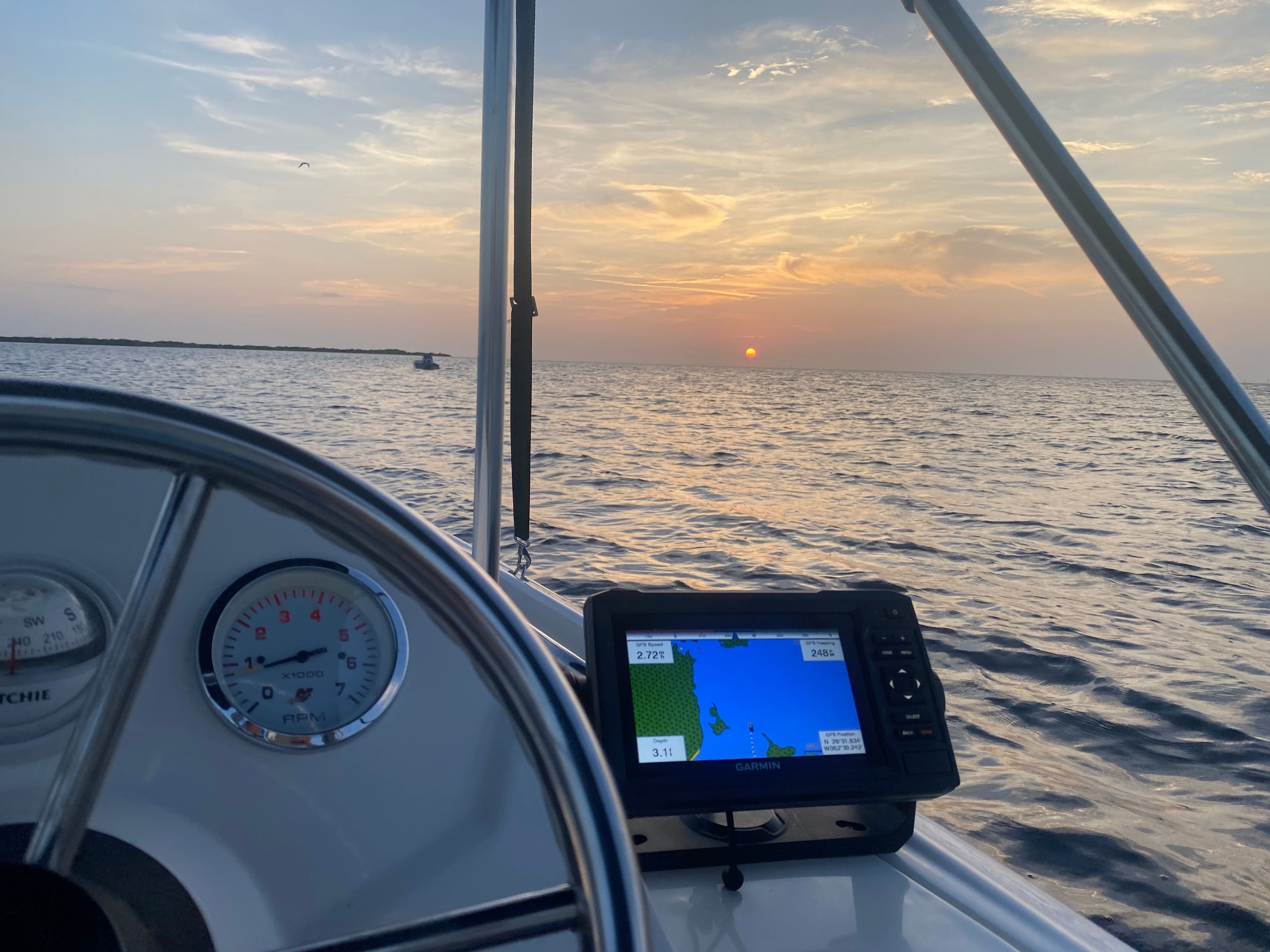 Boston Whaler 150 Super Sport 2018 at sea during sunset.