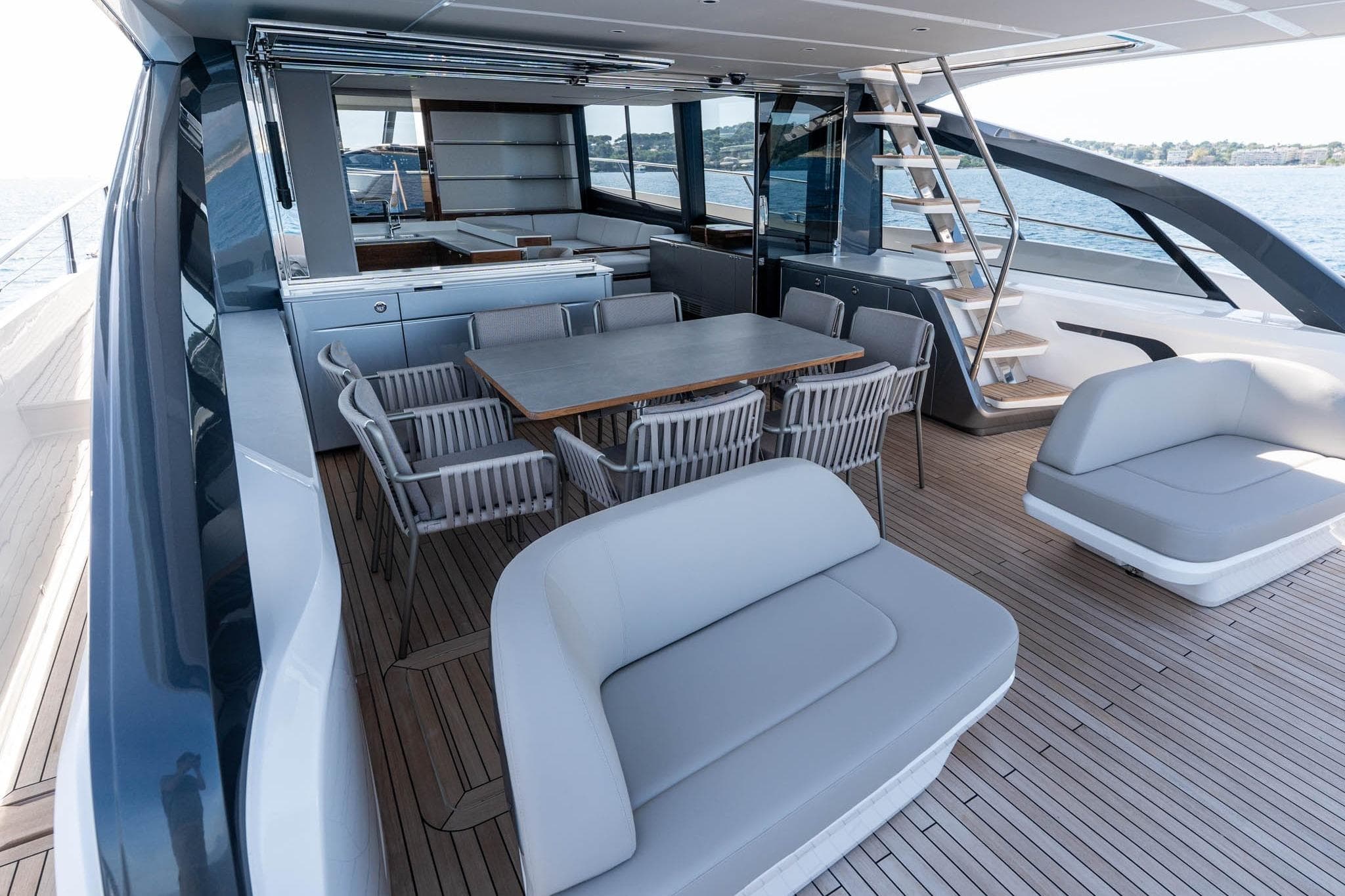 Luxurious 2025 Princess S80 yacht deck with elegant seating and dining area.