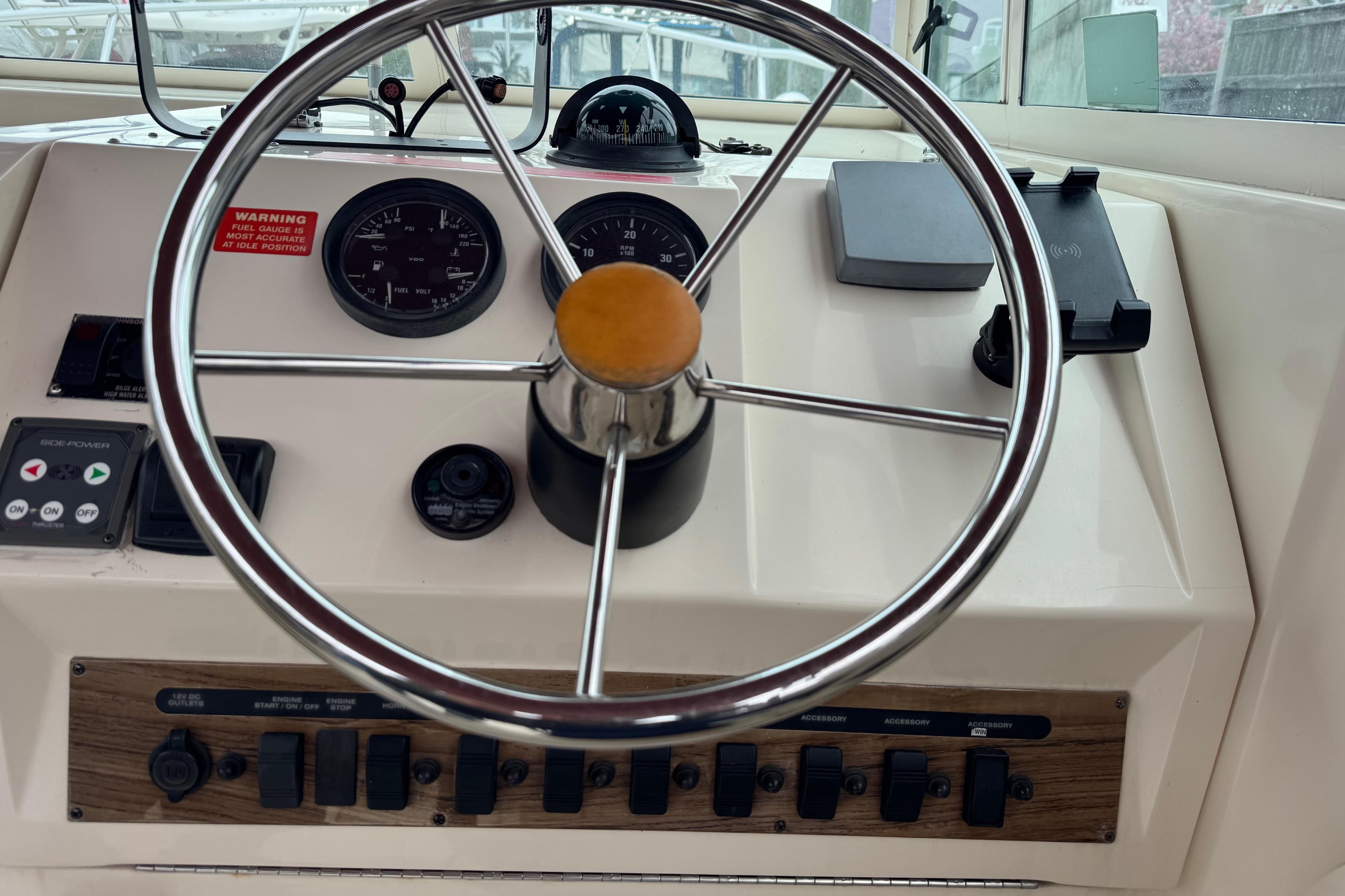 2001 Mainship Pilot 30 helm with steering wheel, gauges, and control panel.
