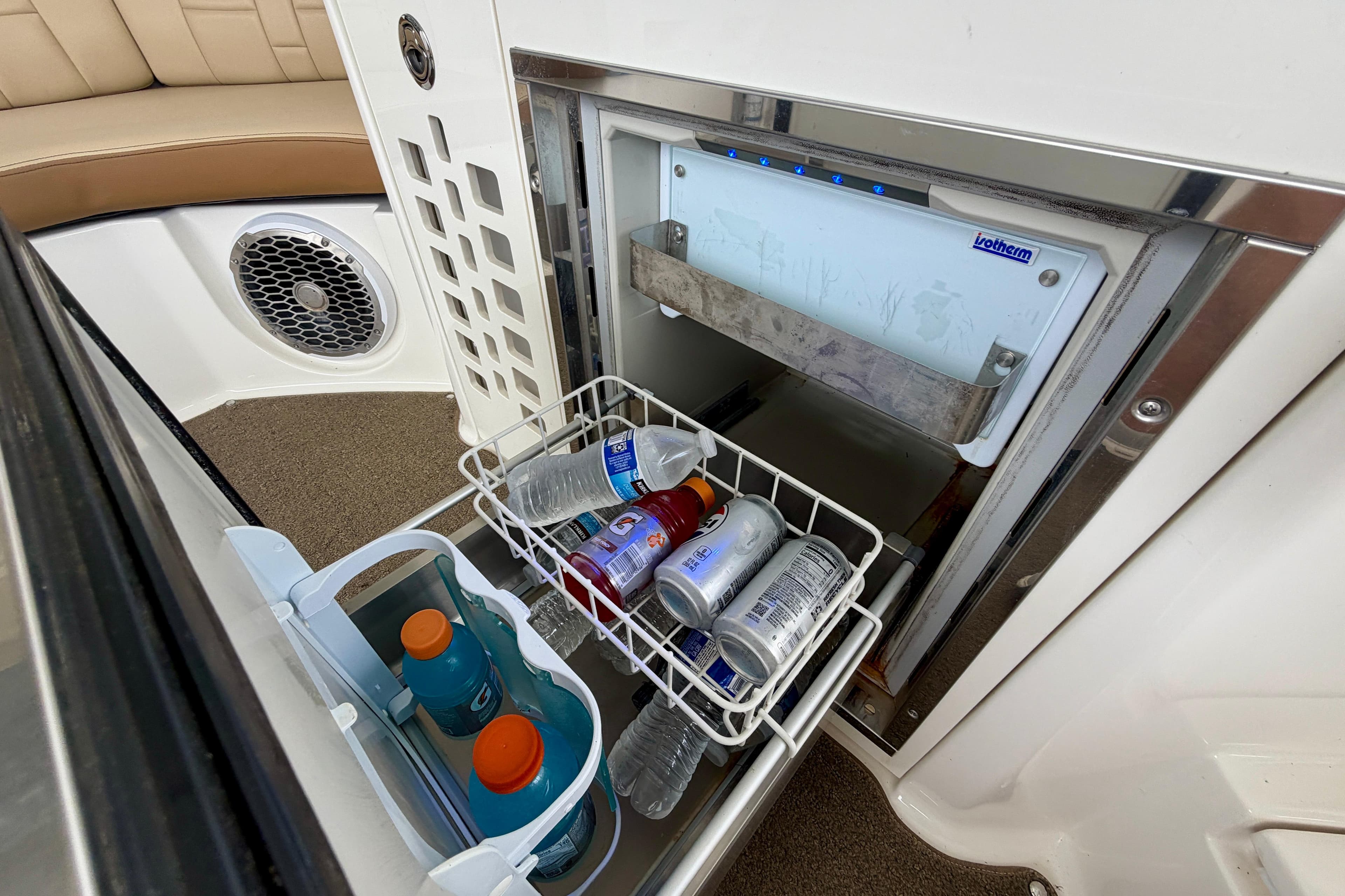 Open fridge on 2015 Sea Ray SLX 350 boat with drinks inside.