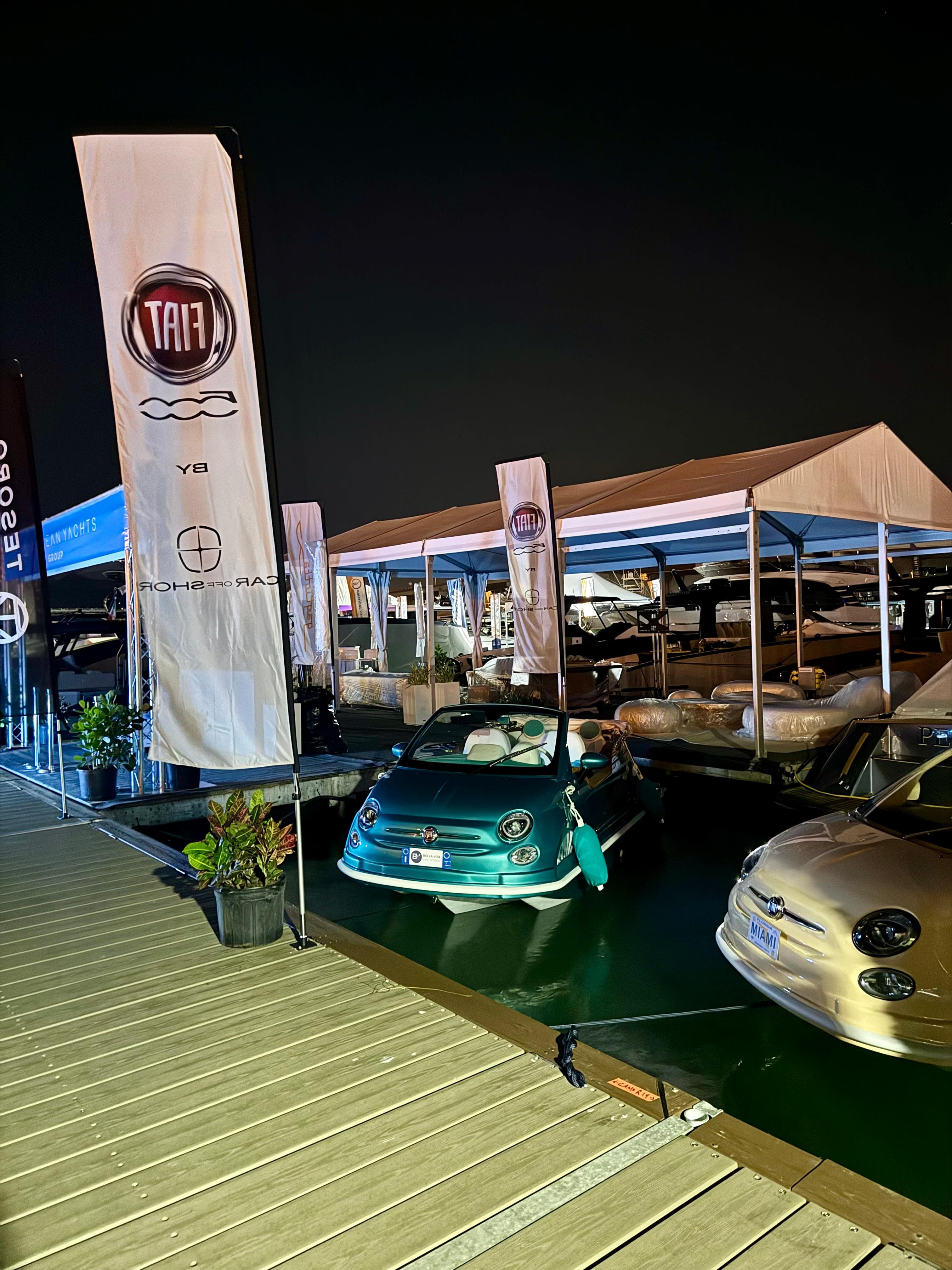 2024 Fiat 500 Car Offshore displayed at a nighttime marina event.