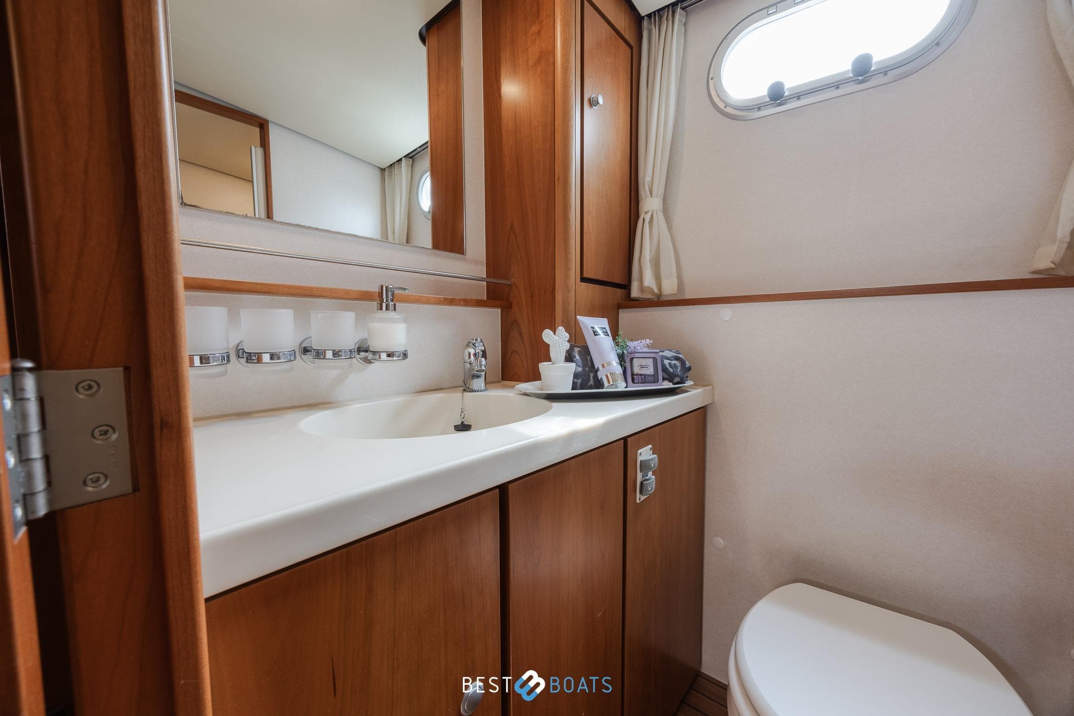 Luxurious bathroom in 2010 Linssen Grand Sturdy 43.9 AC yacht, featuring wooden cabinetry.