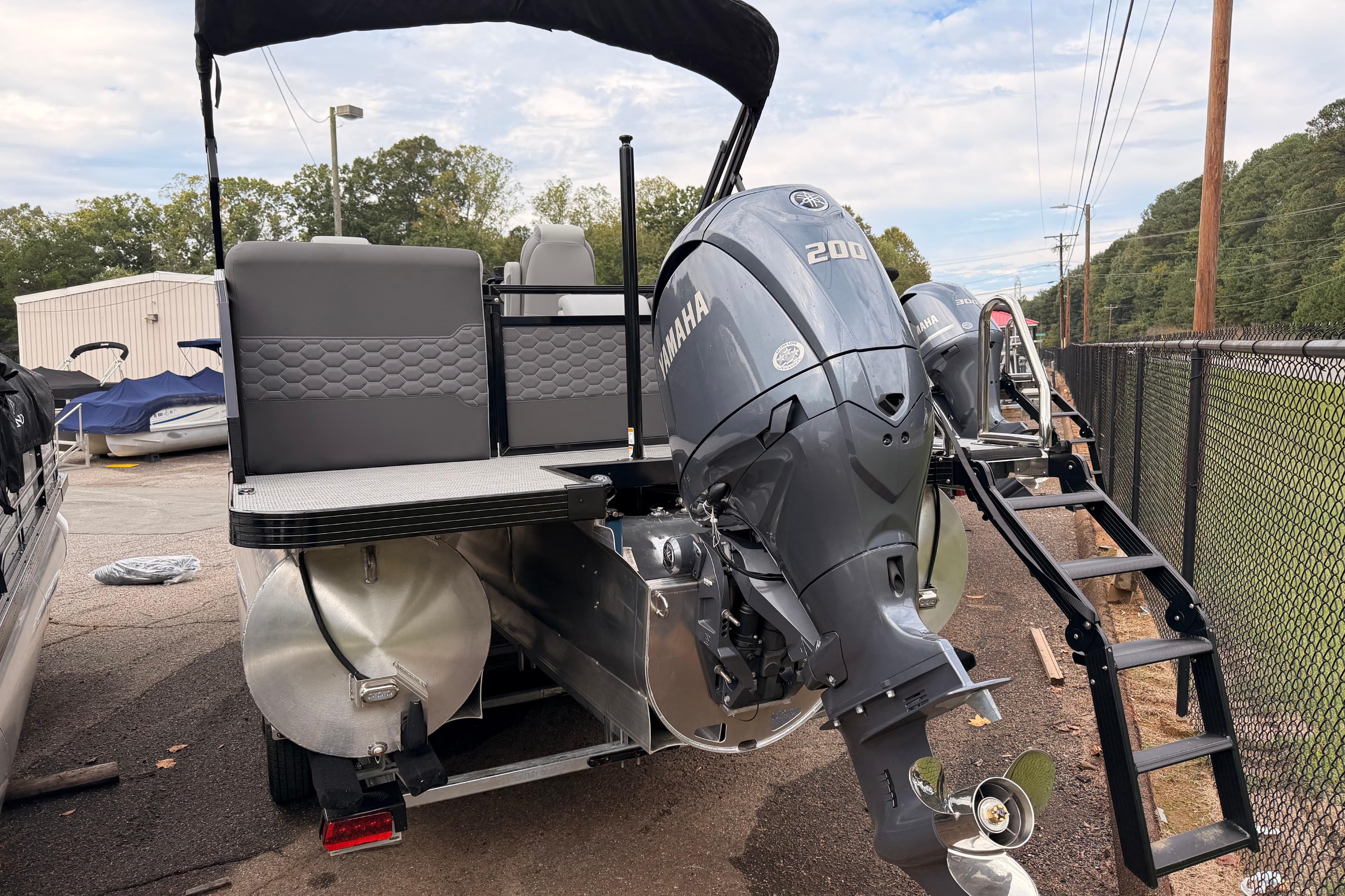 2026 Veranda VR 235 RC pontoon boat with Yamaha 200 outboard motor, parked outdoors.
