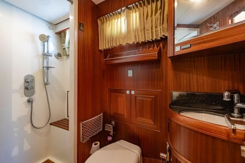 Luxurious bathroom in 2019 Selene 42 Voyager Sedan yacht with wood accents and modern fixtures.