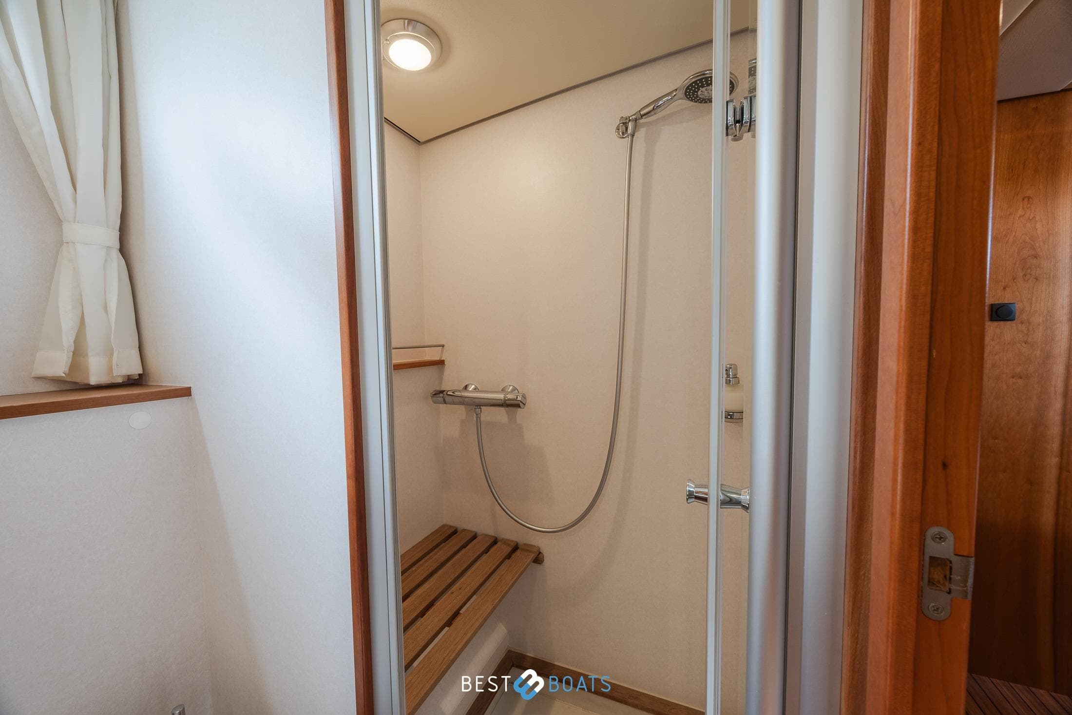 Shower area in 2010 Linssen Grand Sturdy 43.9 AC yacht with wooden bench.