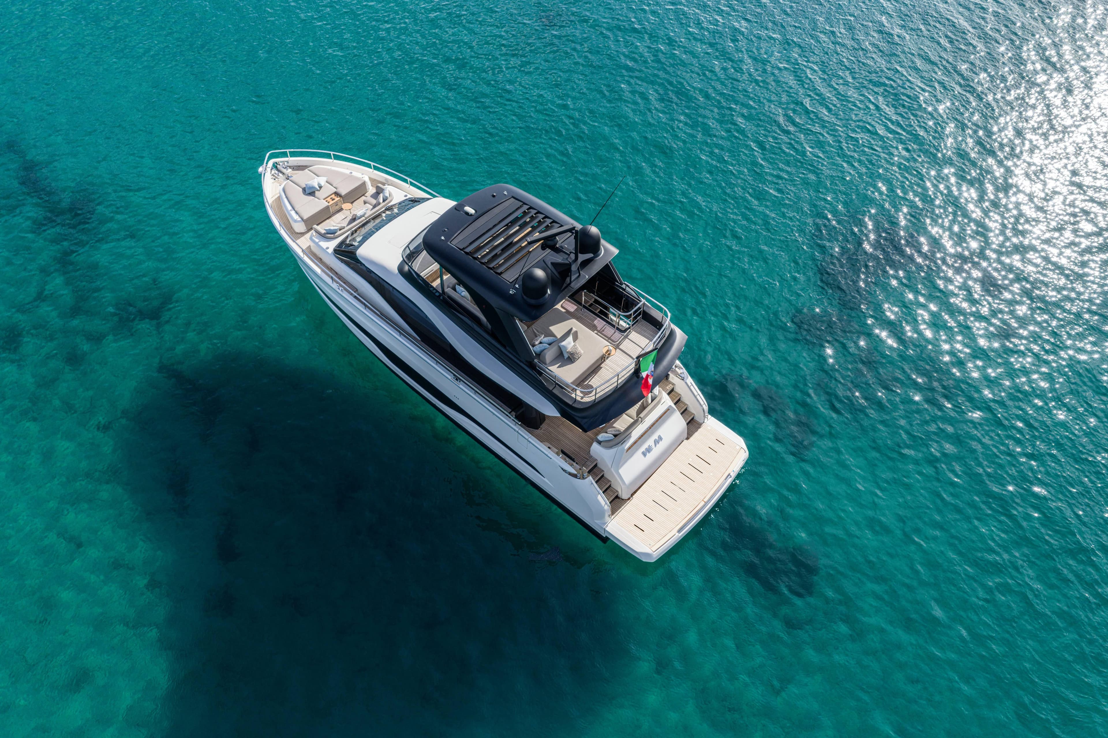 Aerial view of 2026 Cranchi Sessantadue 62 yacht on clear turquoise water.