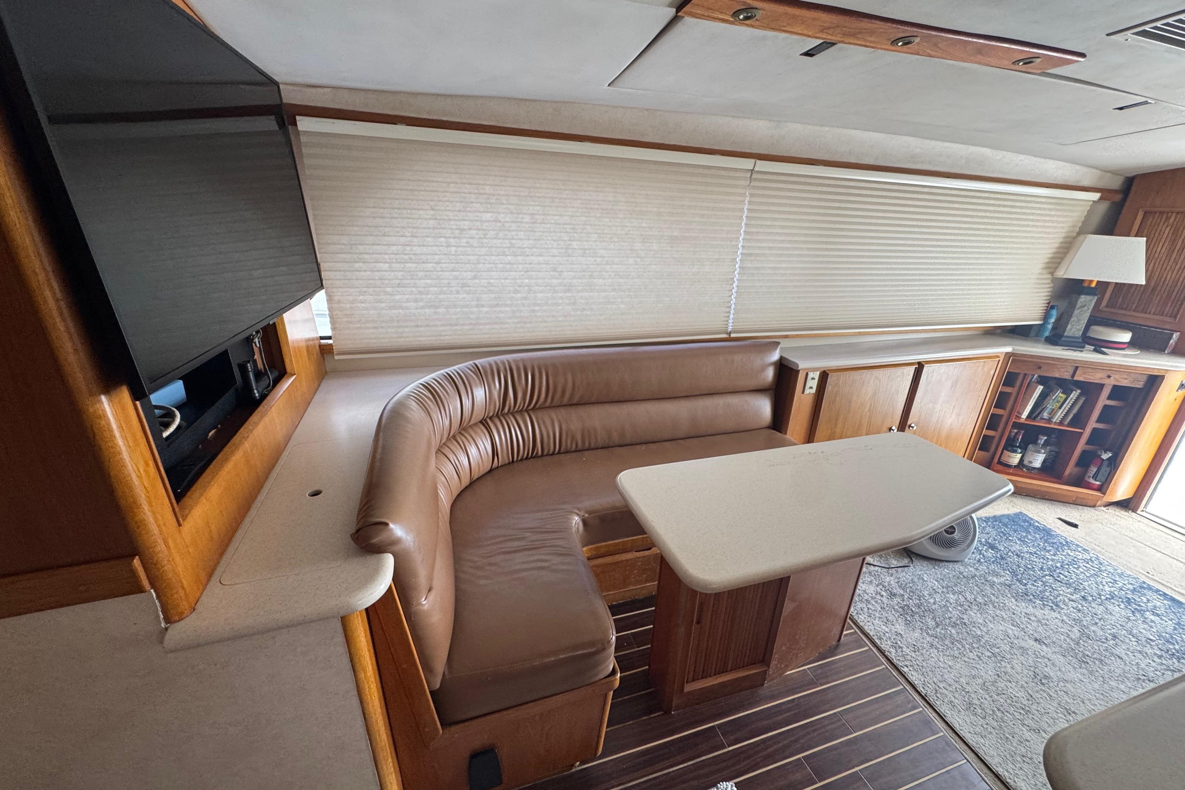 Interior of 1988 Bertram 50 Convertible yacht with leather seating and wooden cabinetry.