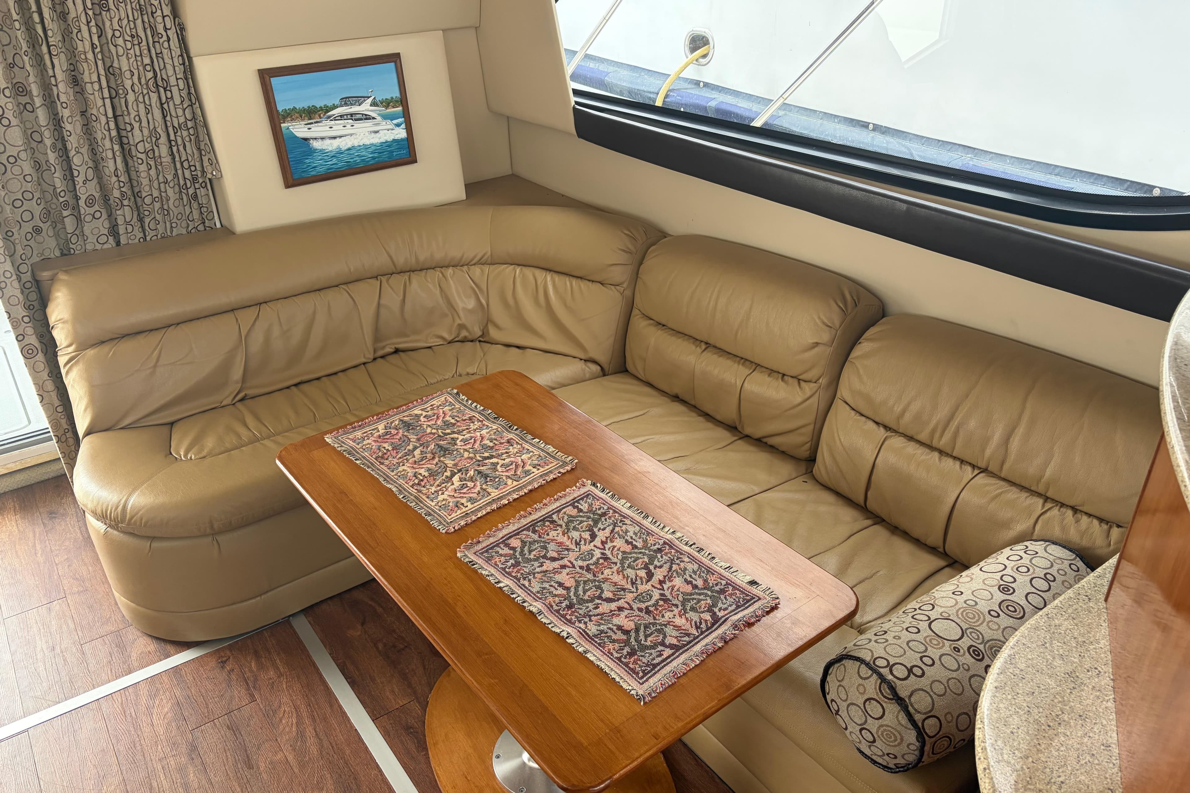 Luxurious interior of 2006 Meridian 411 Sedan with leather seating and wooden table.