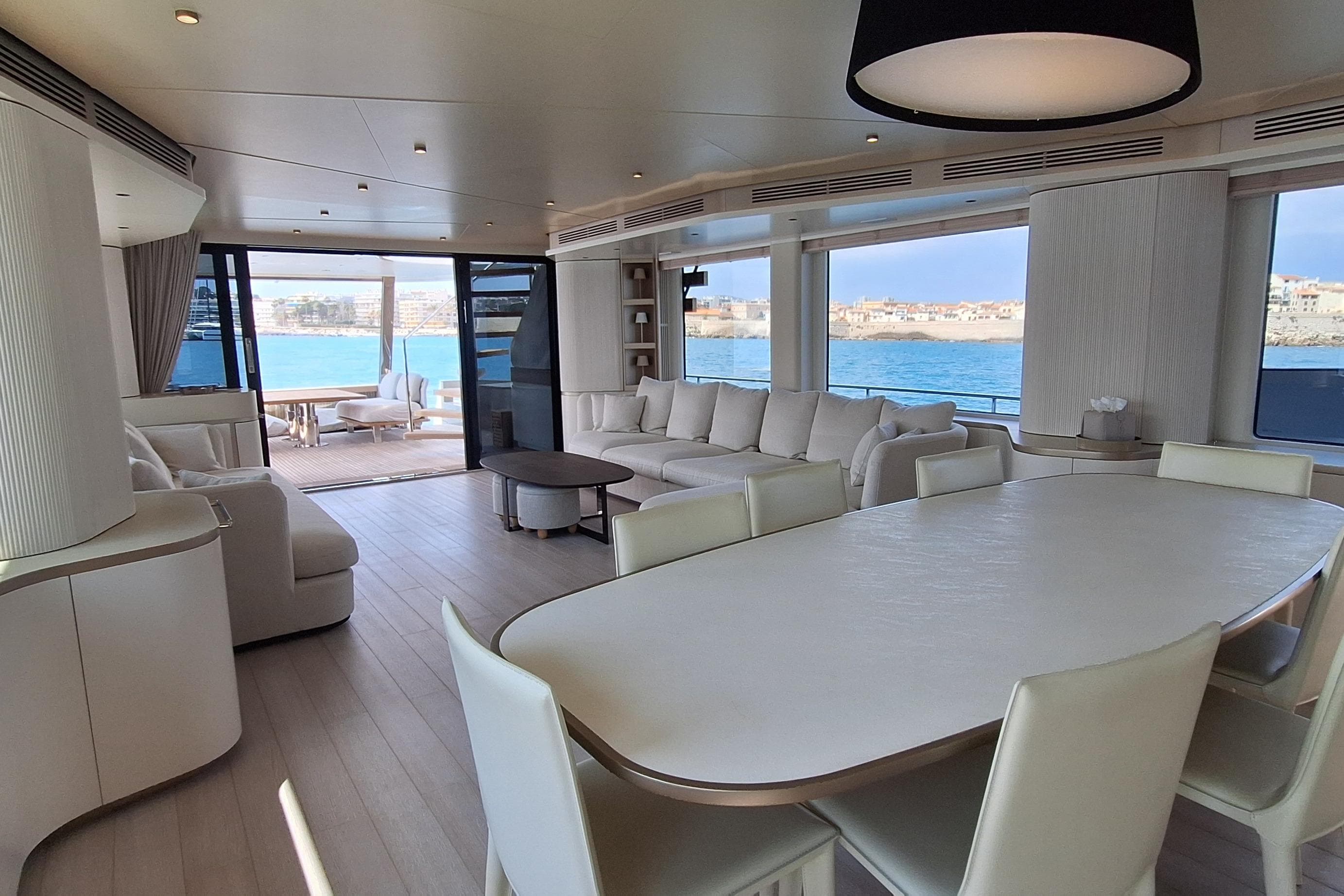 Luxurious interior of 2022 Azimut Magellano 25M yacht with elegant seating and ocean view.