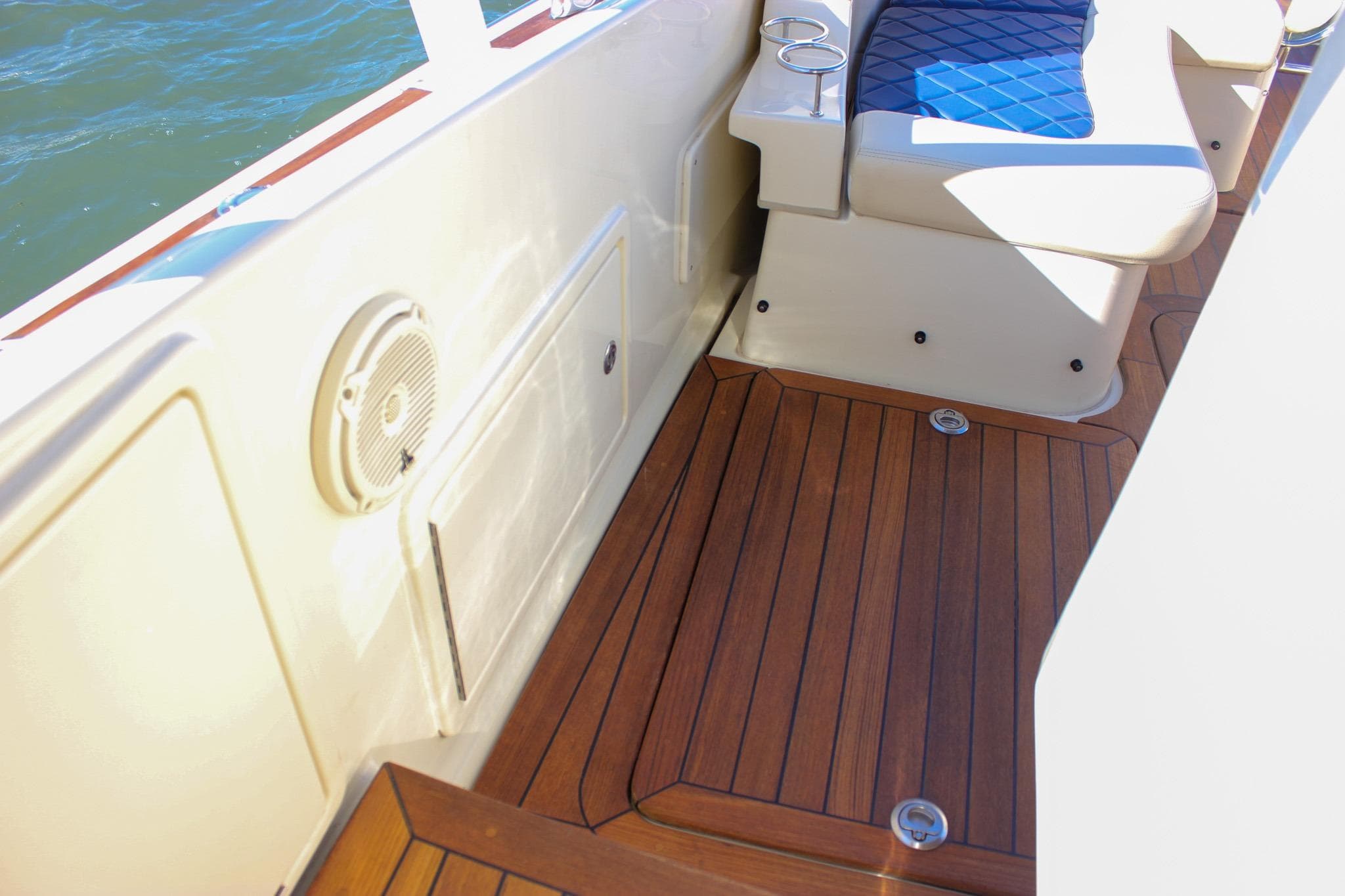 2017 Chris-Craft Launch 38 interior with teak flooring and cushioned seating.