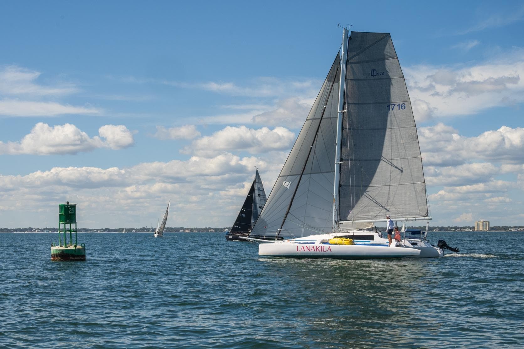 Sailboat "Lanakila" Corsair 970, 2017 model, sailing near buoy on a sunny day.