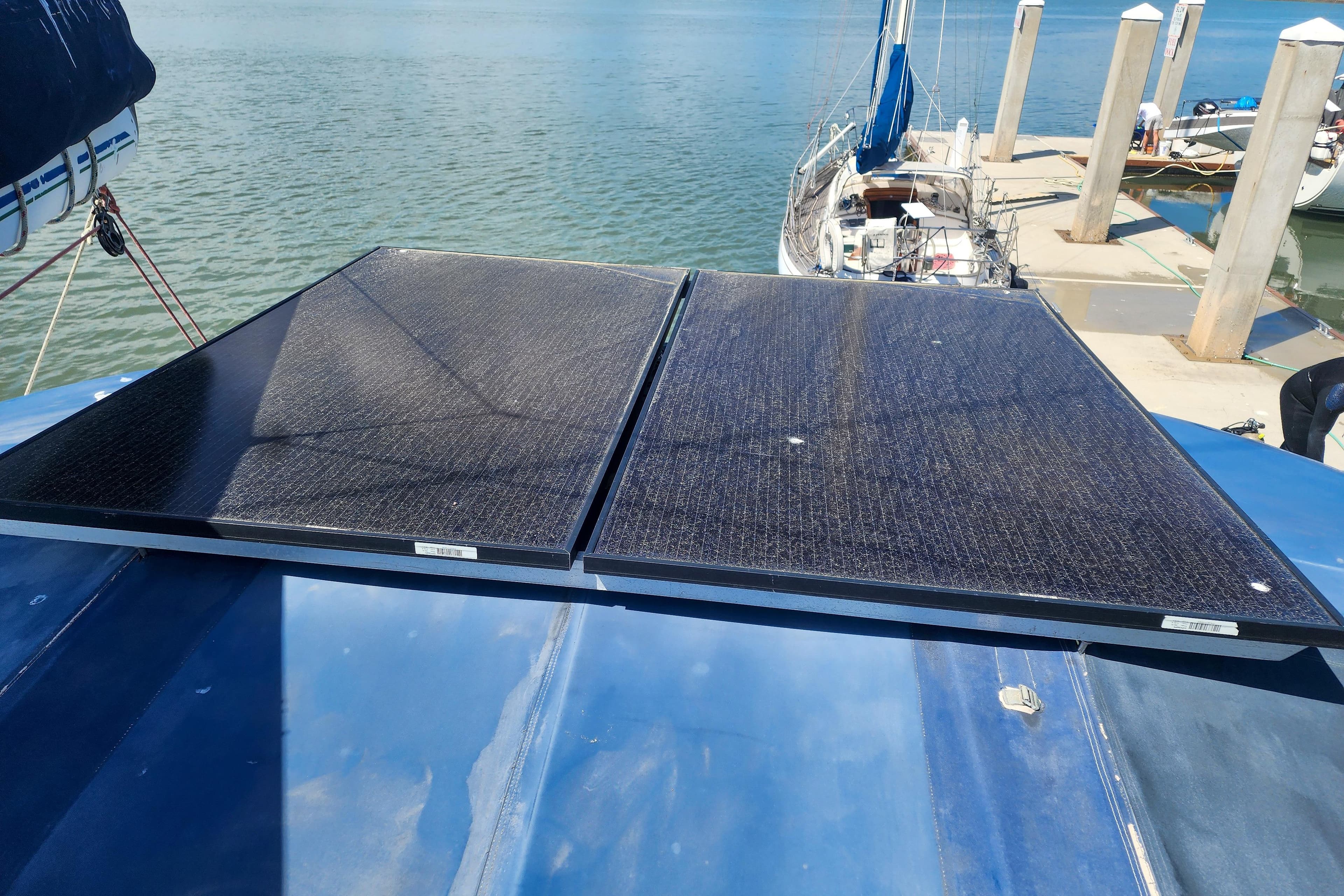 Solar panels on a 2001 Privilege 435 yacht docked by the water.
