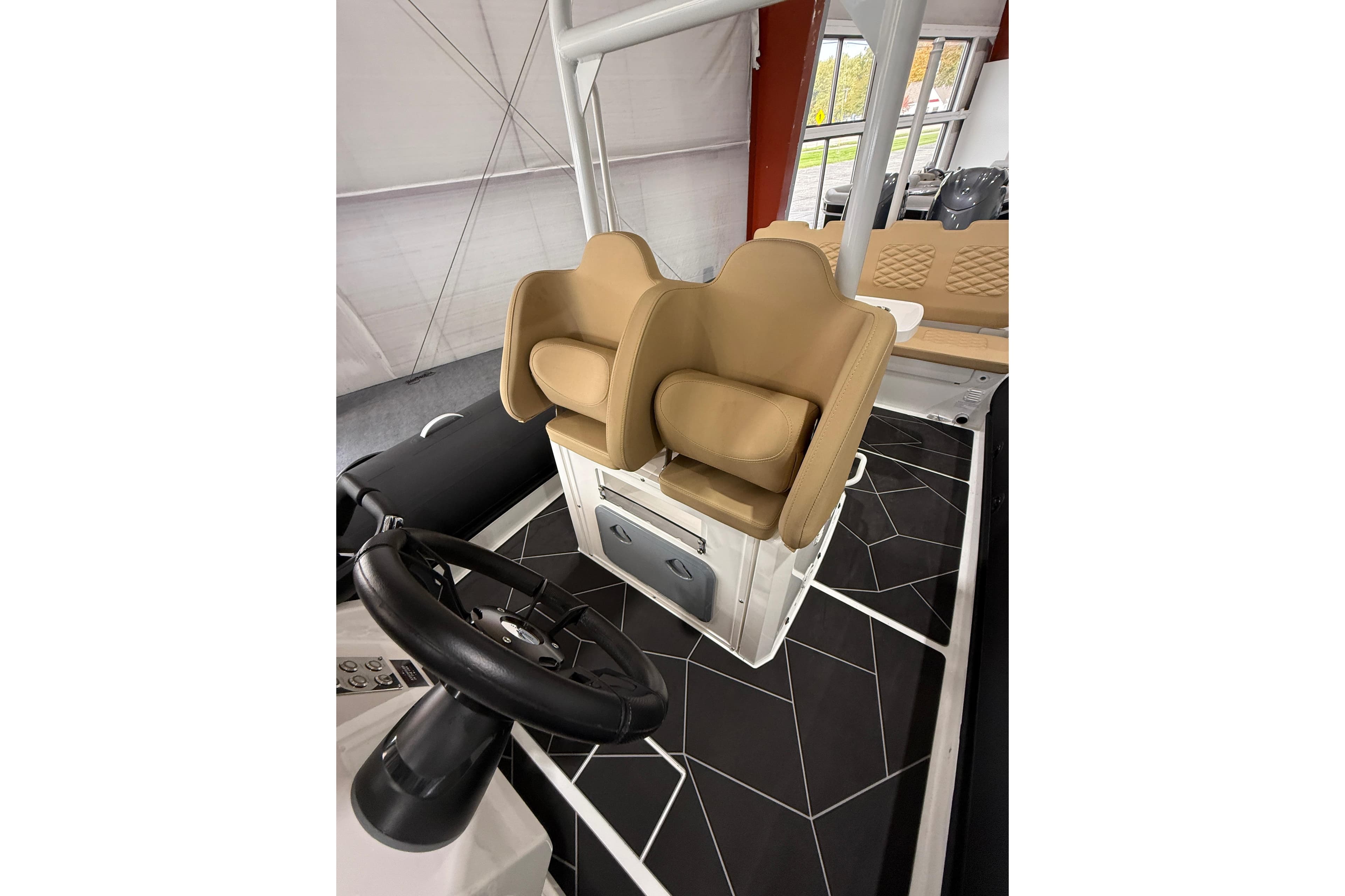 2026 Highfield Sport 800 boat interior with tan seats and black steering wheel.