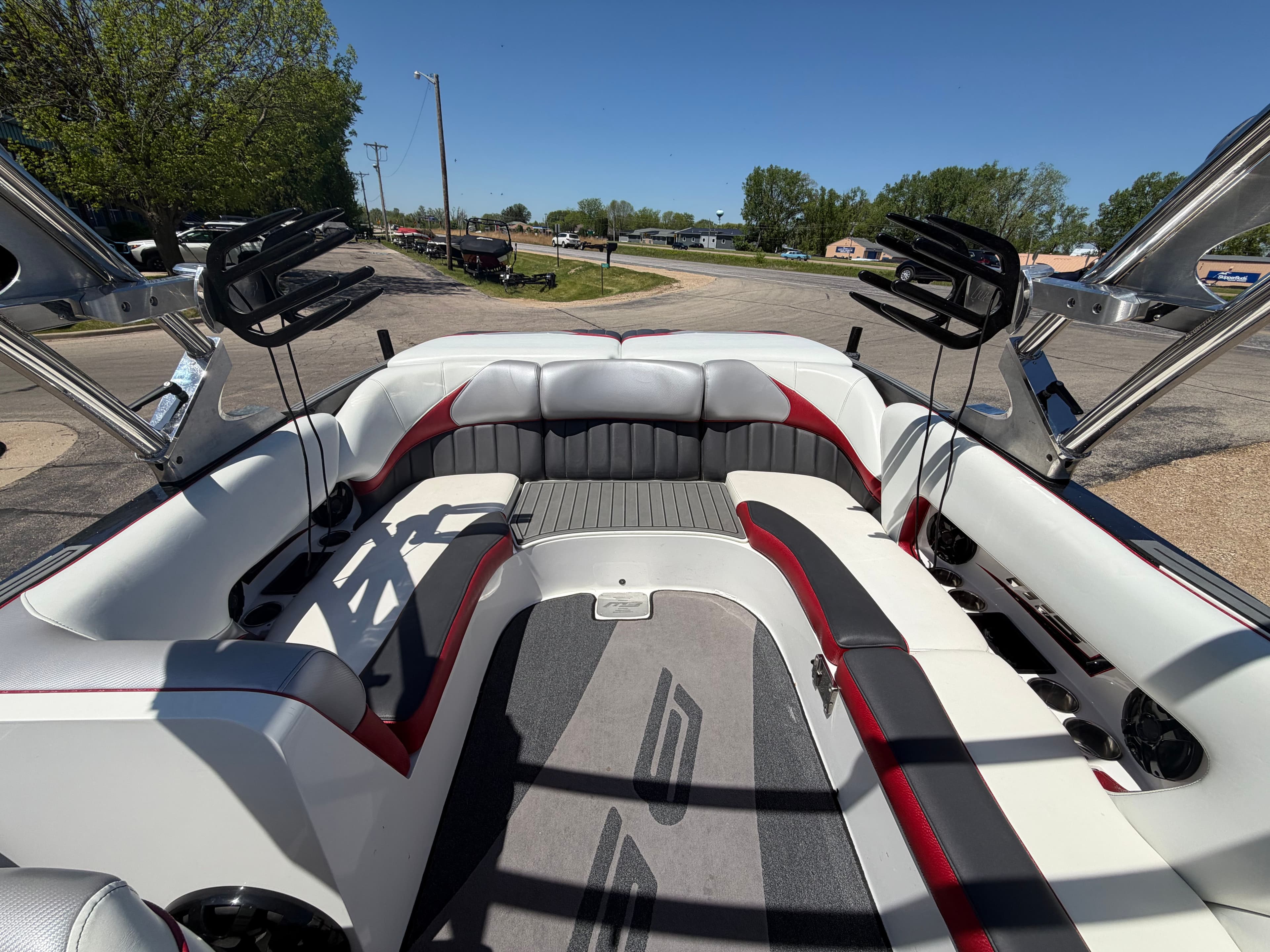Interior of a 2015 MB SPORTS B52 23 boat with gray and red seating.