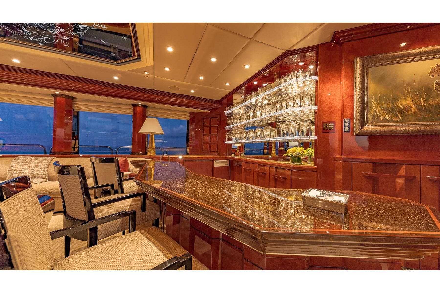 Luxurious interior of 2002 Christensen Tri Deck yacht with elegant bar and seating area.