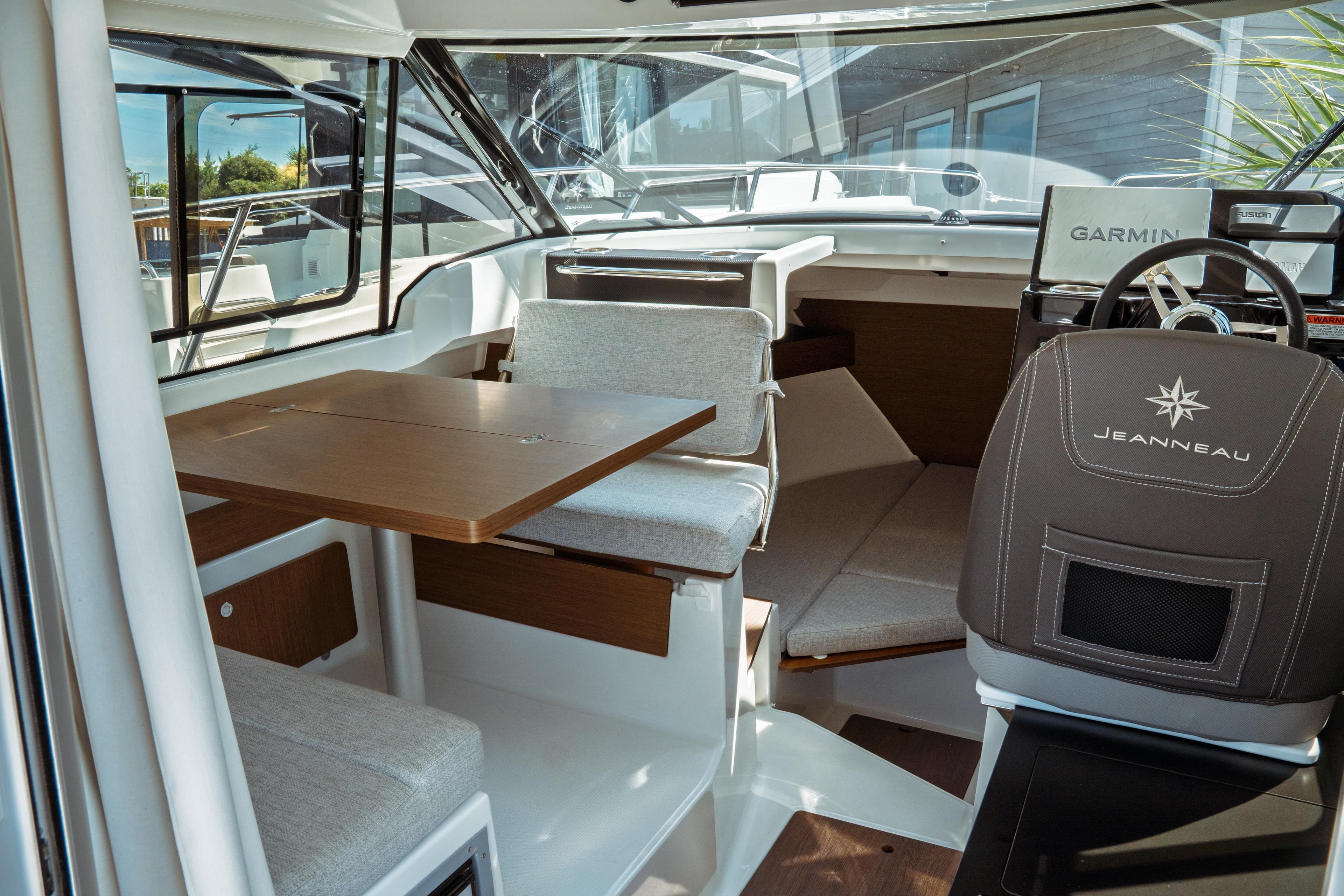 Interior of 2023 Jeanneau NC Weekender 795 Series 2, featuring seating and navigation area.