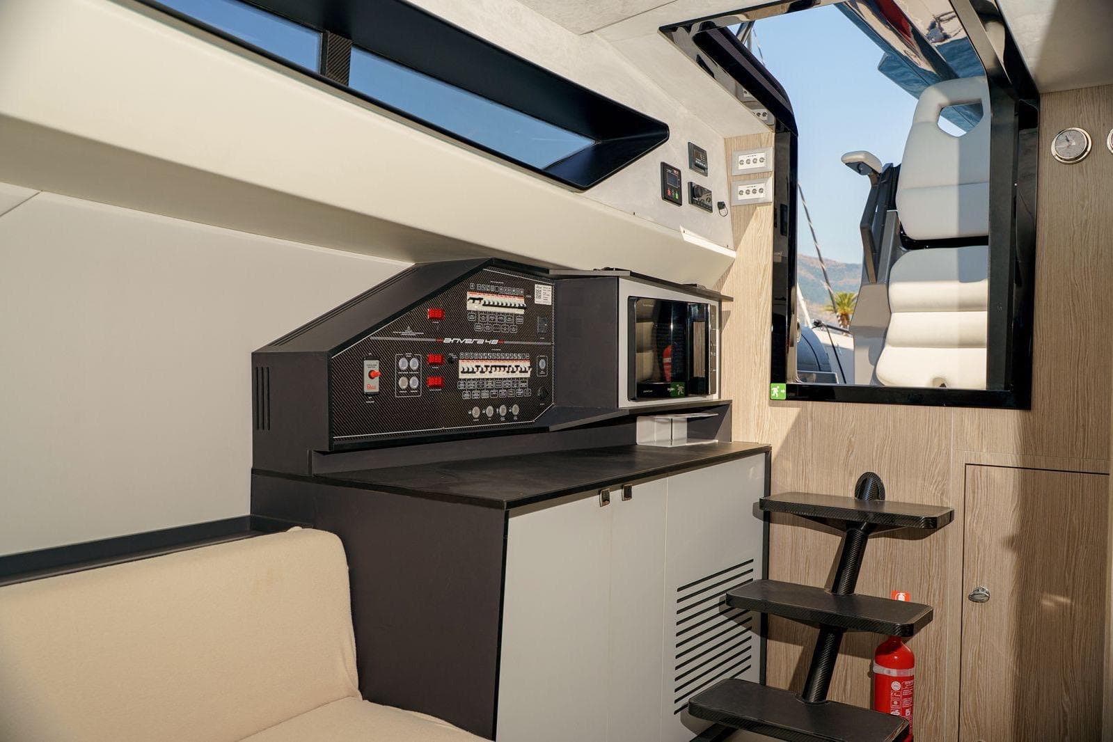 Interior of 2023 Anvera 48 yacht featuring control panel and modern seating.