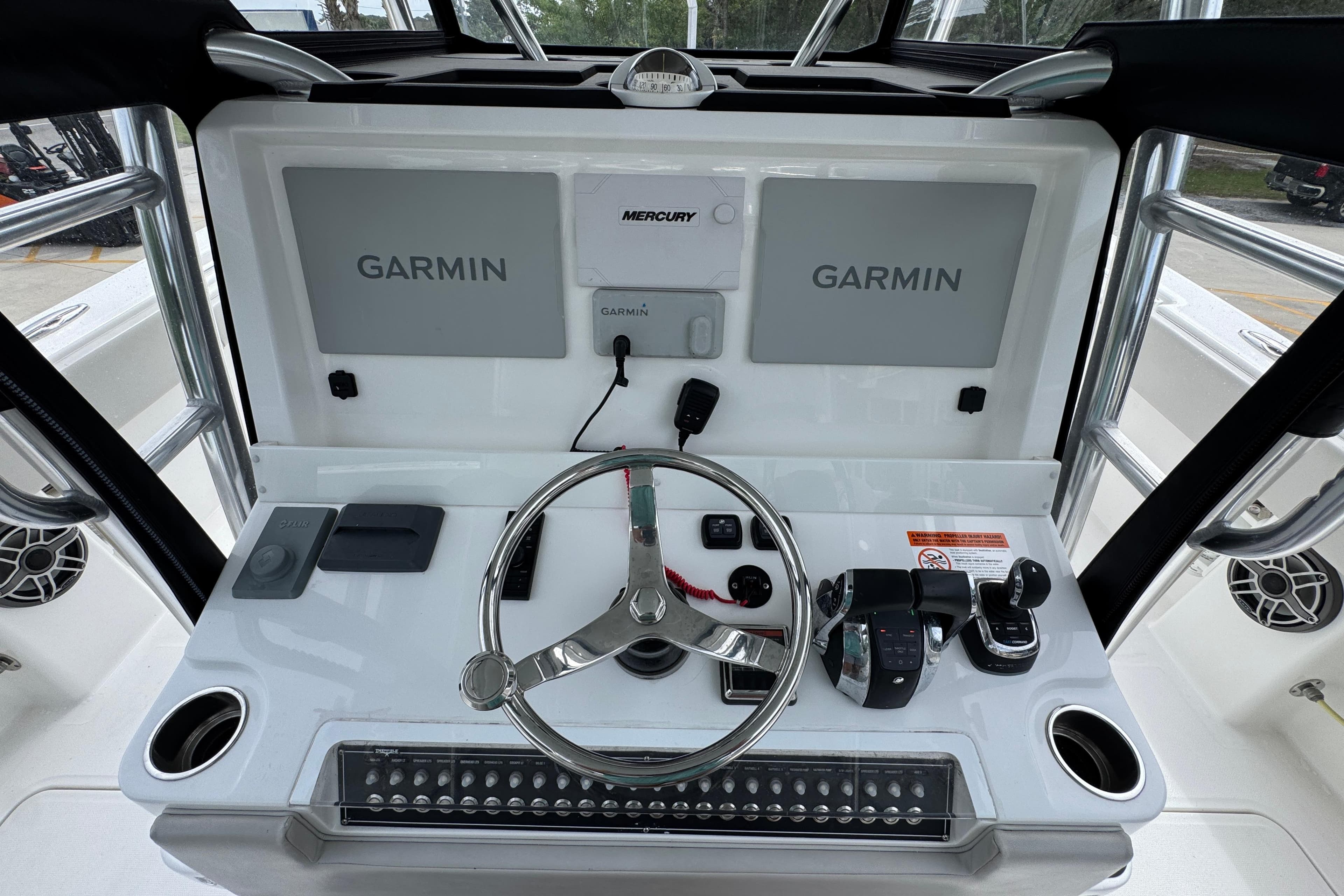 Helm of 2020 Invincible 35 Catamaran with Garmin displays and Mercury controls.