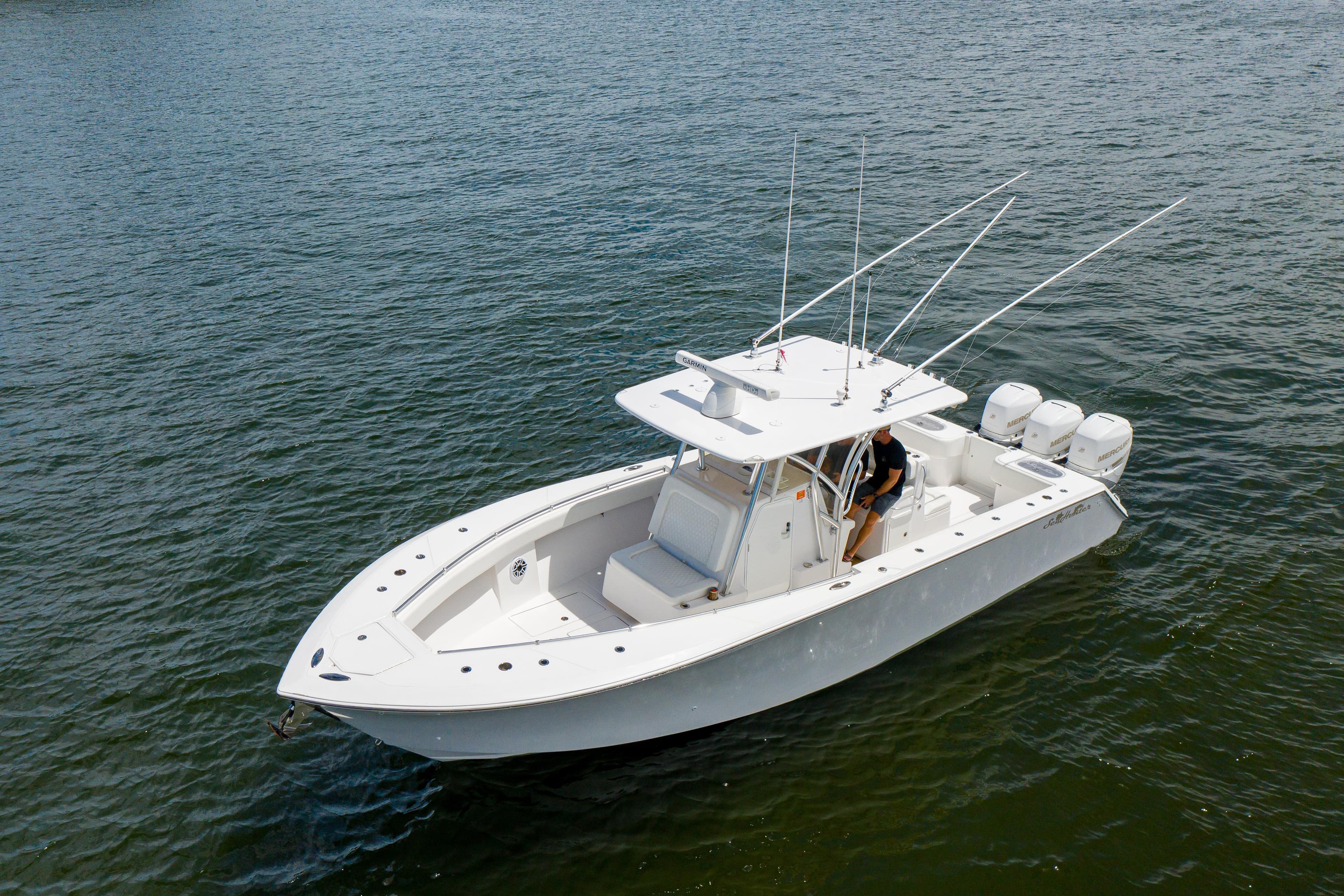 2018 SeaHunter 33 Tournament boat on water, featuring triple outboard engines.