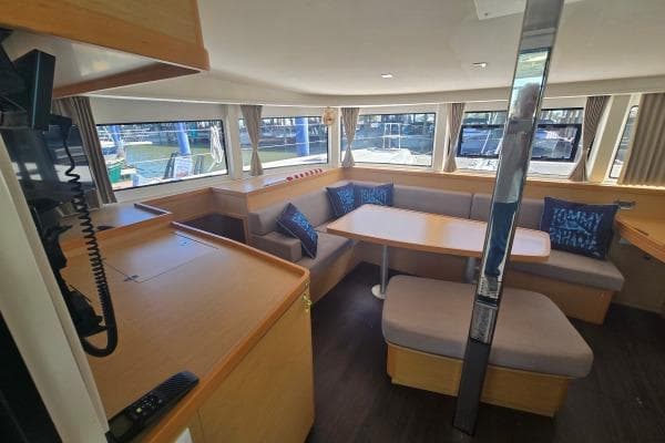 Spacious interior of 2018 Lagoon 42 catamaran with dining area and large windows.