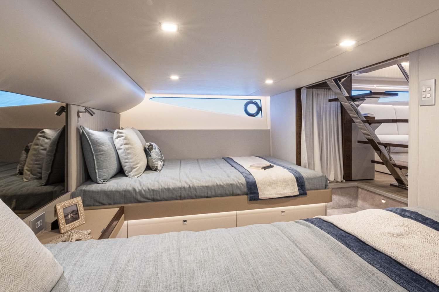 Manufacturer Provided Image: Luxurious cabin interior of 2026 Riviera 4300 Sport Express yacht with modern bedding and decor.