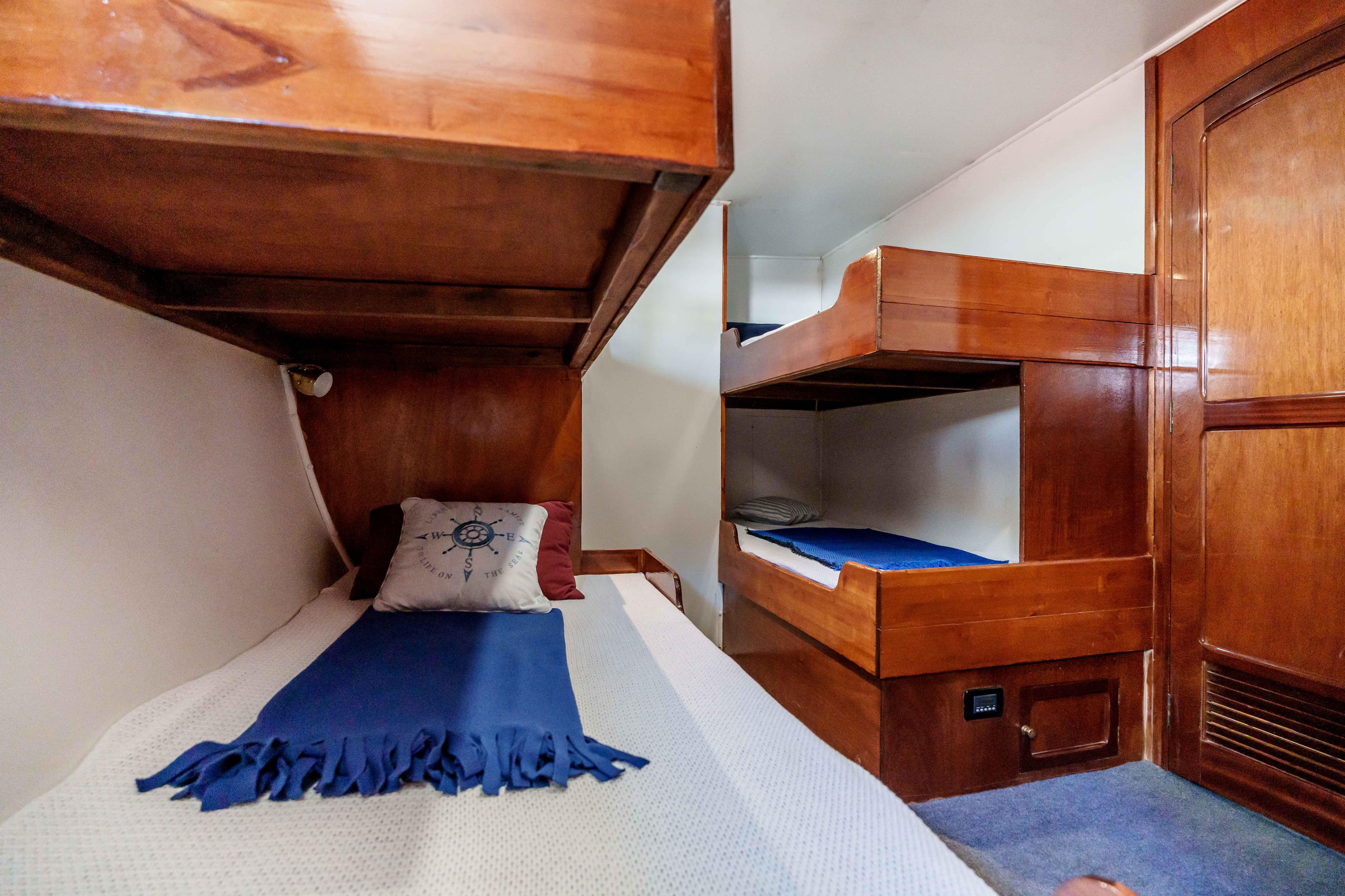 Cozy wooden bunk beds in 1983 Cavalier 92 yacht cabin interior.