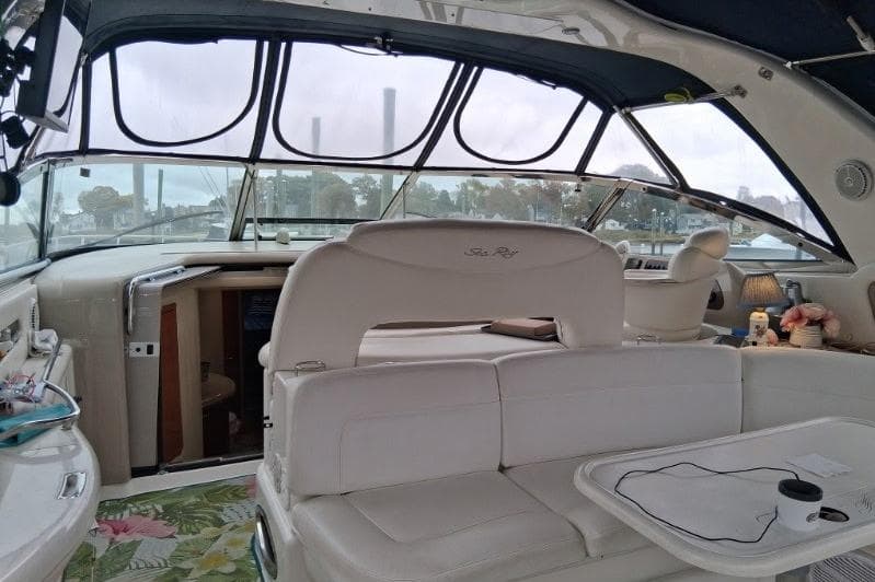 Interior of 2000 Sea Ray 460 Sundancer yacht with white seating and panoramic windows.