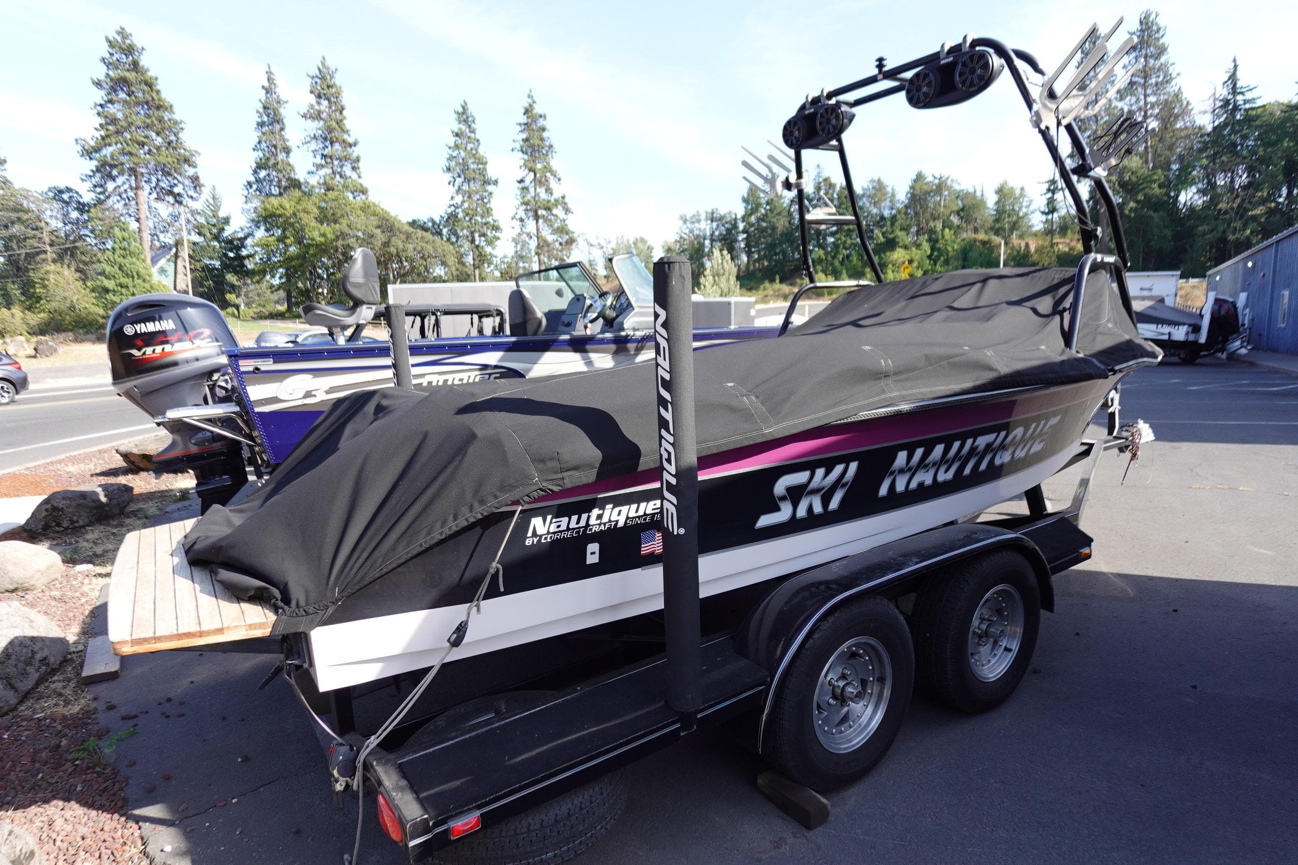 1993 Correct Craft Ski Nautique 200 Closed Bow boat on trailer, covered and parked outdoors.