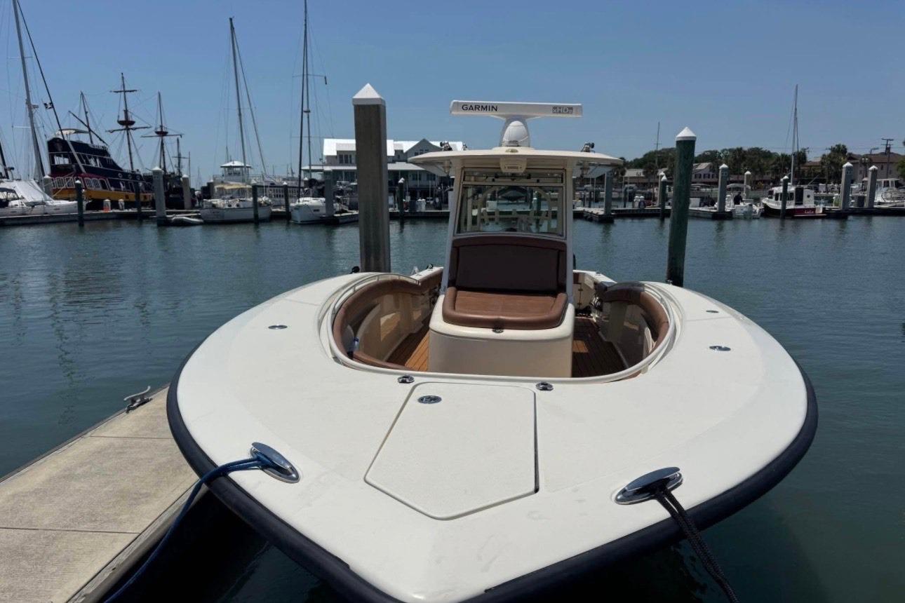 2017 Scout 350 LXF boat docked at marina with clear sky background.