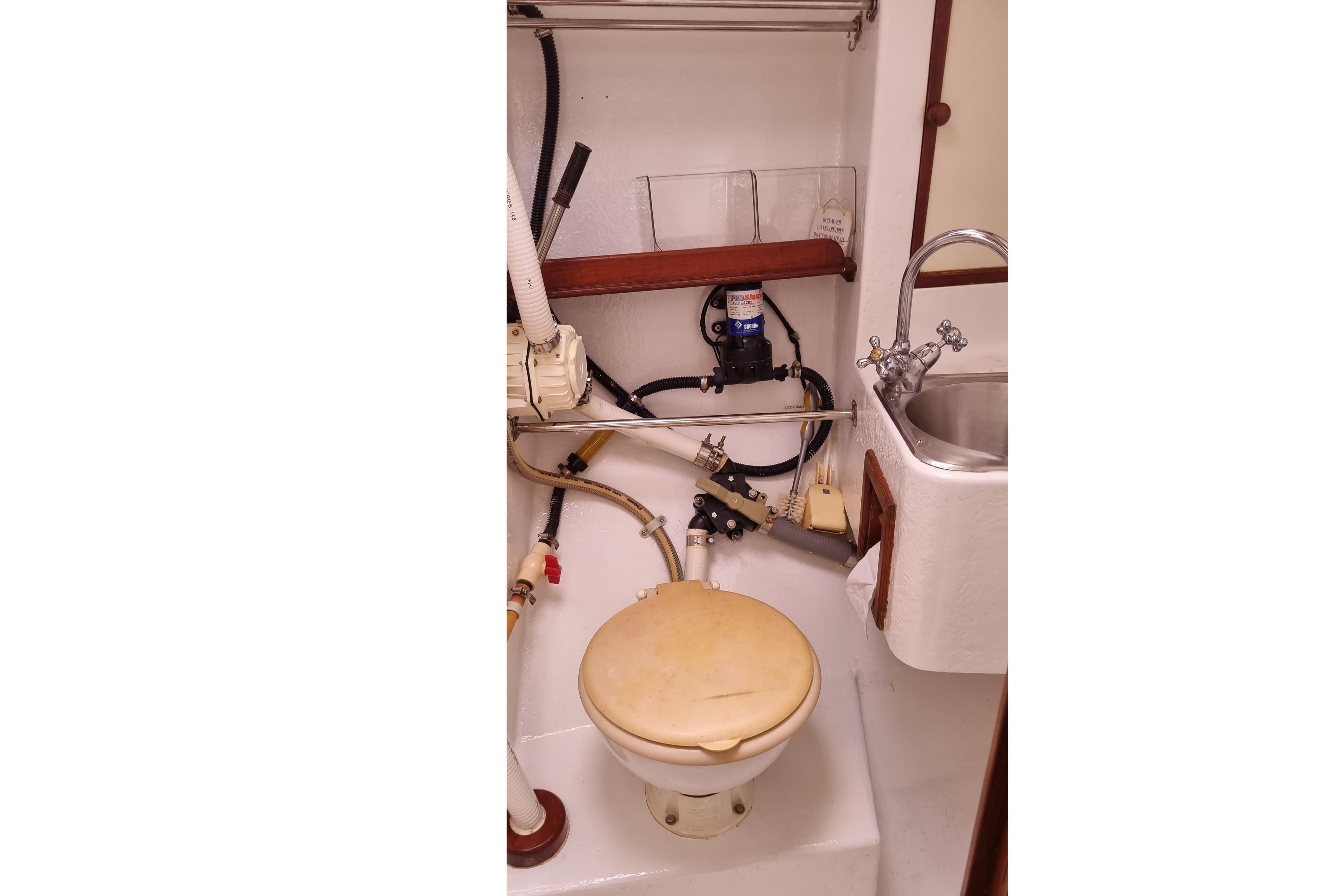 1989 Bruce Roberts Offshore 38 yacht bathroom with toilet and sink.
