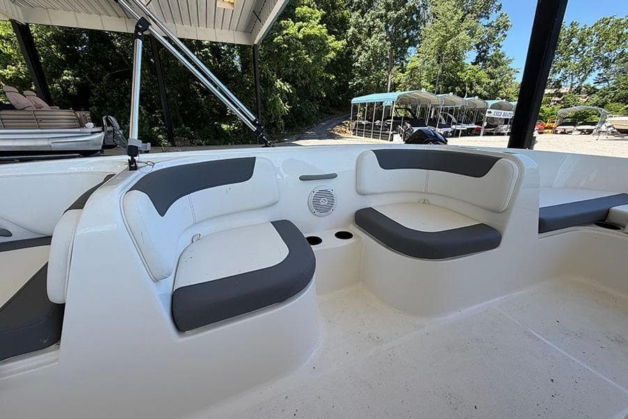 2026 Bayliner Element E18 boat interior with cushioned seating and cup holders.