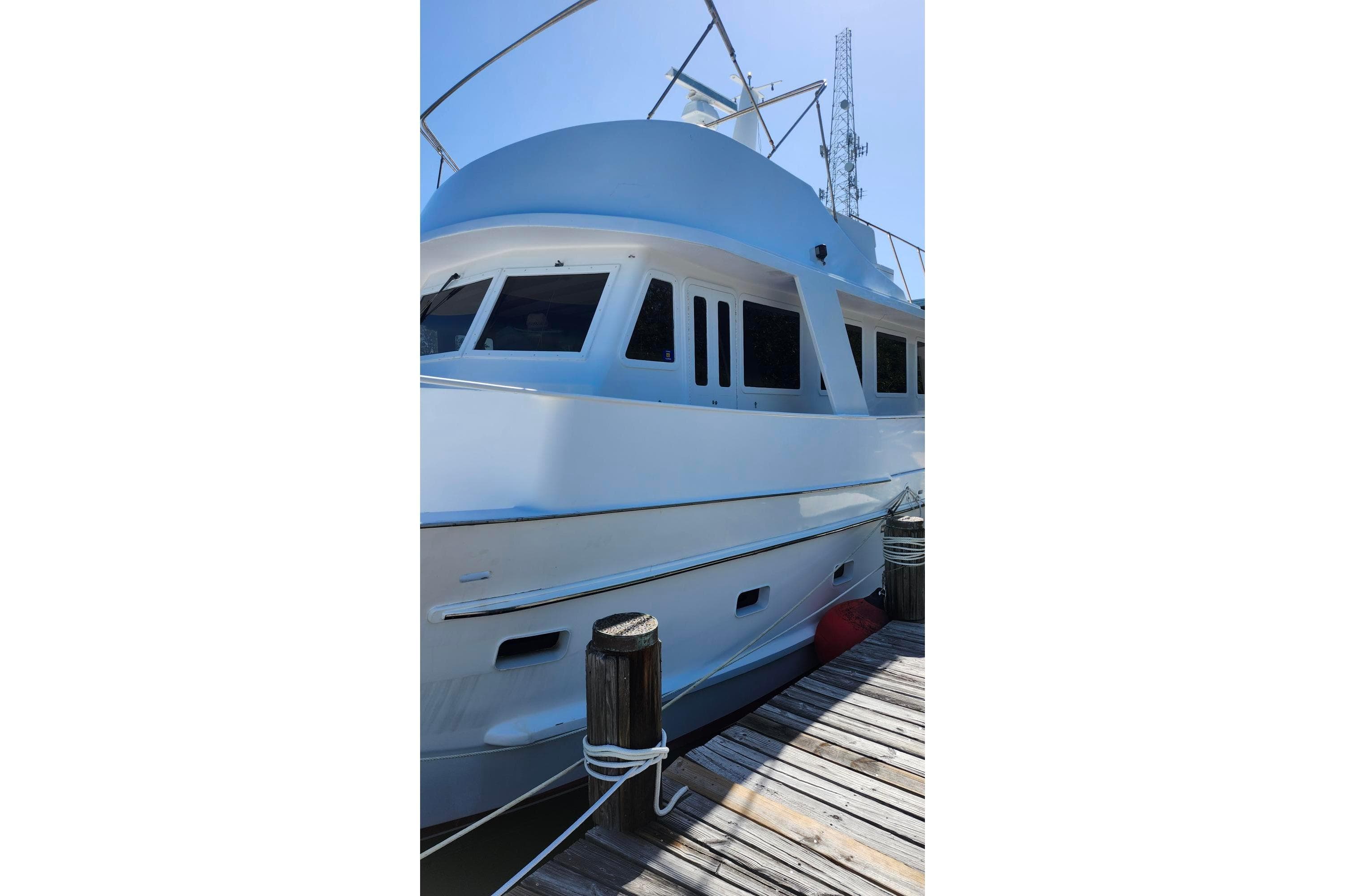 1979 Marine Trader 50 Trawler docked, showcasing sleek design and spacious windows.