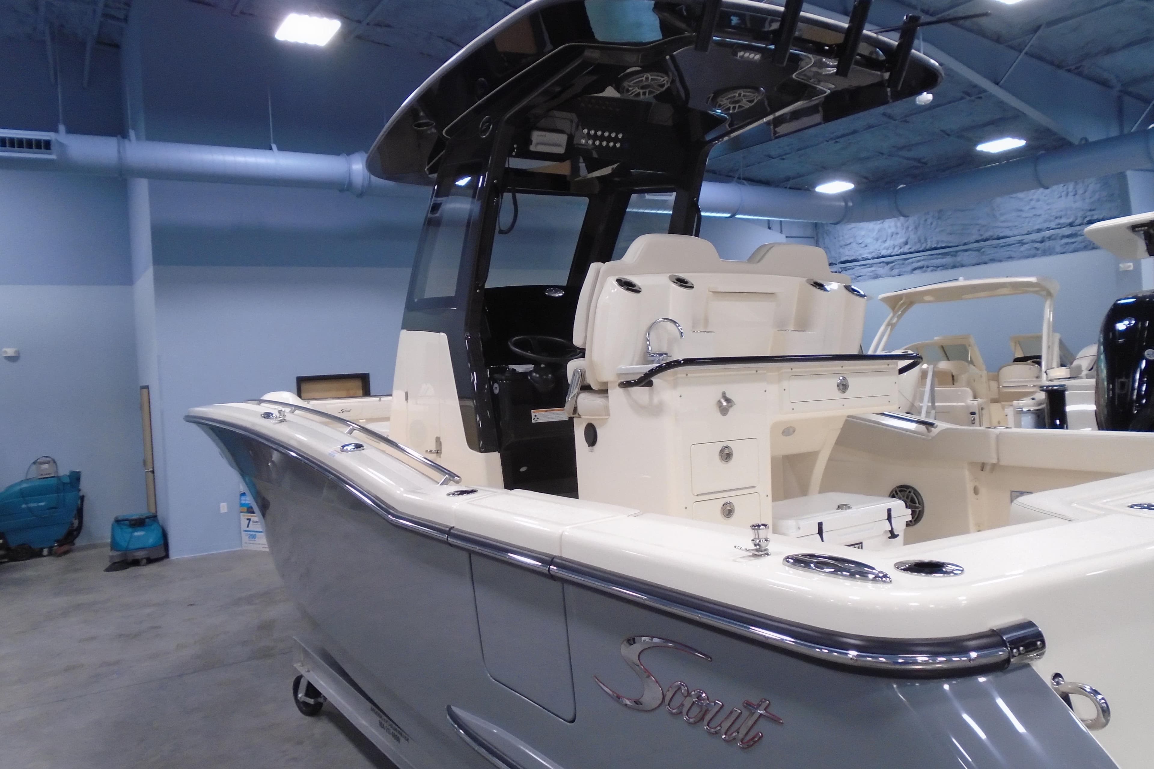 2026 Scout 288 LXF boat in showroom, featuring sleek design and modern amenities.
