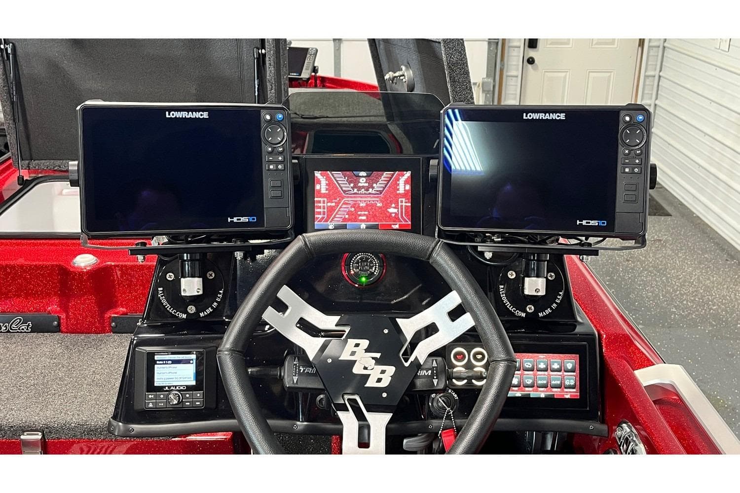 2024 Bass Cat Puma STS dashboard with dual Lowrance HDS10 displays and steering wheel.