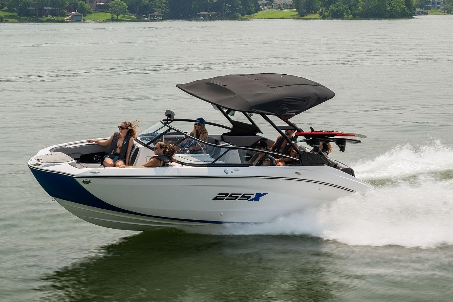 Manufacturer Provided Image: 2026 Yamaha Boats 255XE cruising on a lake with passengers enjoying the ride.