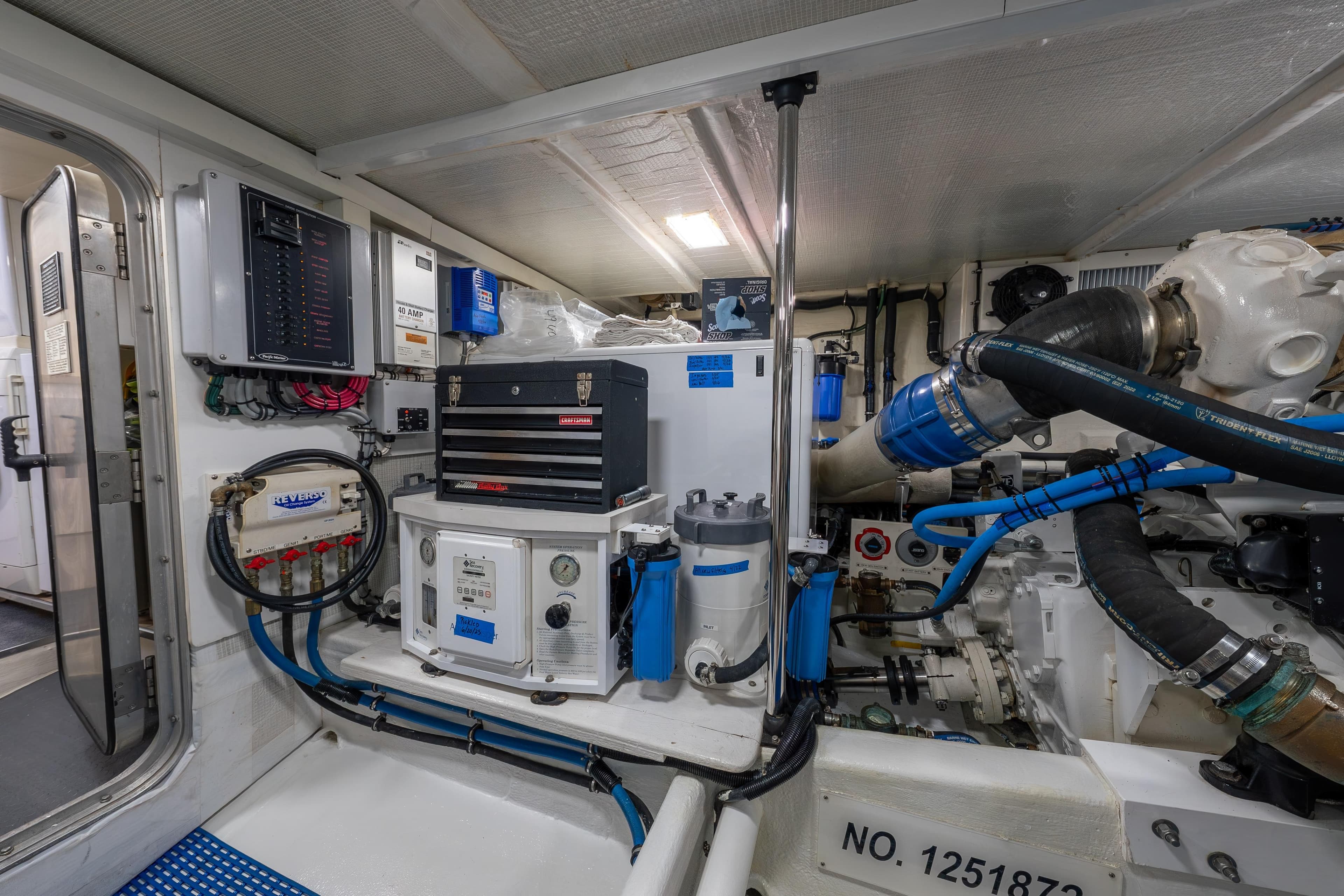 Engine room of a 2007 Pacific Mariner Pilothouse yacht, showcasing mechanical systems and equipment.