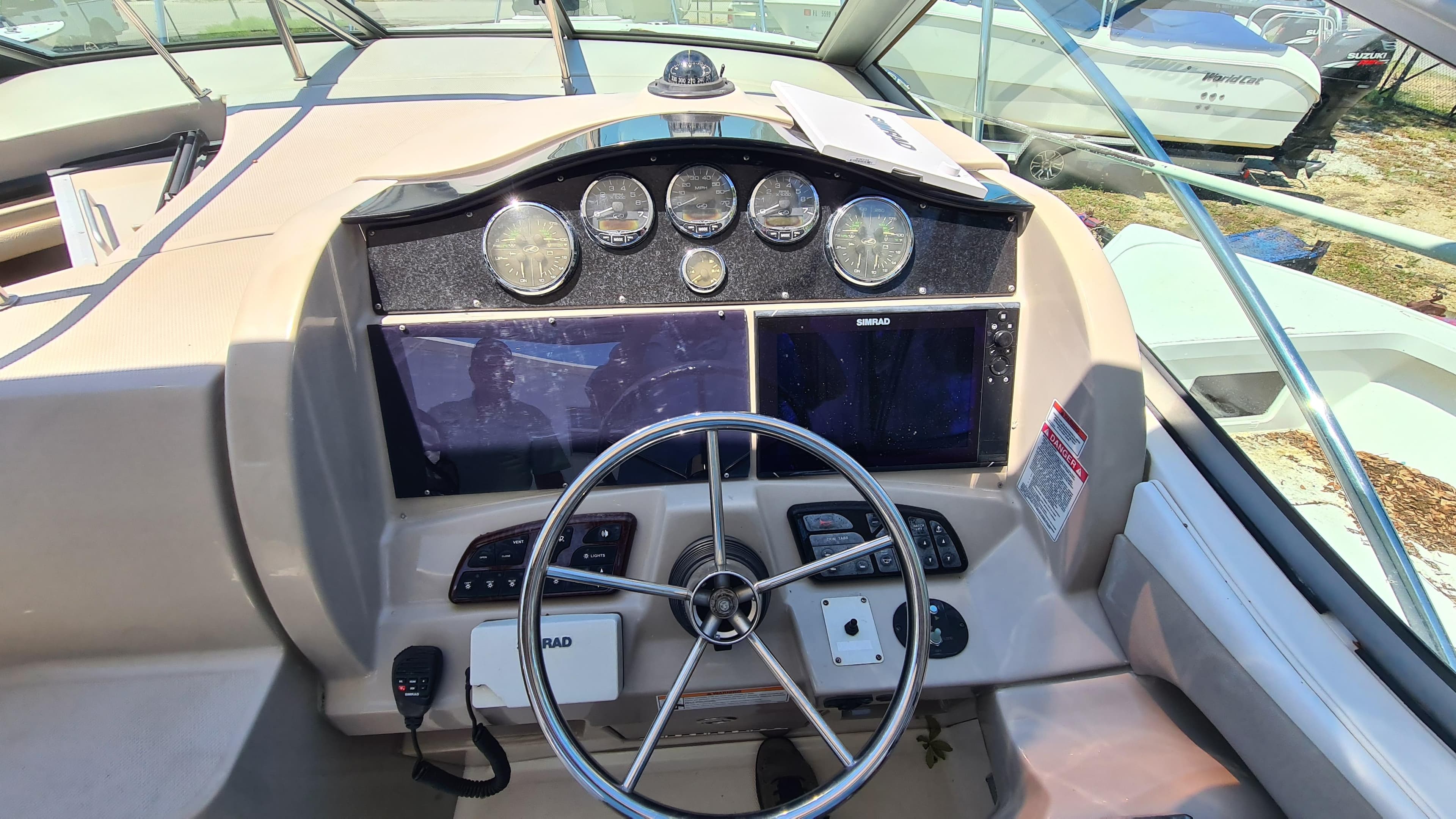 2007 Sea Ray 290 Sundancer helm with steering wheel and instrument panel.