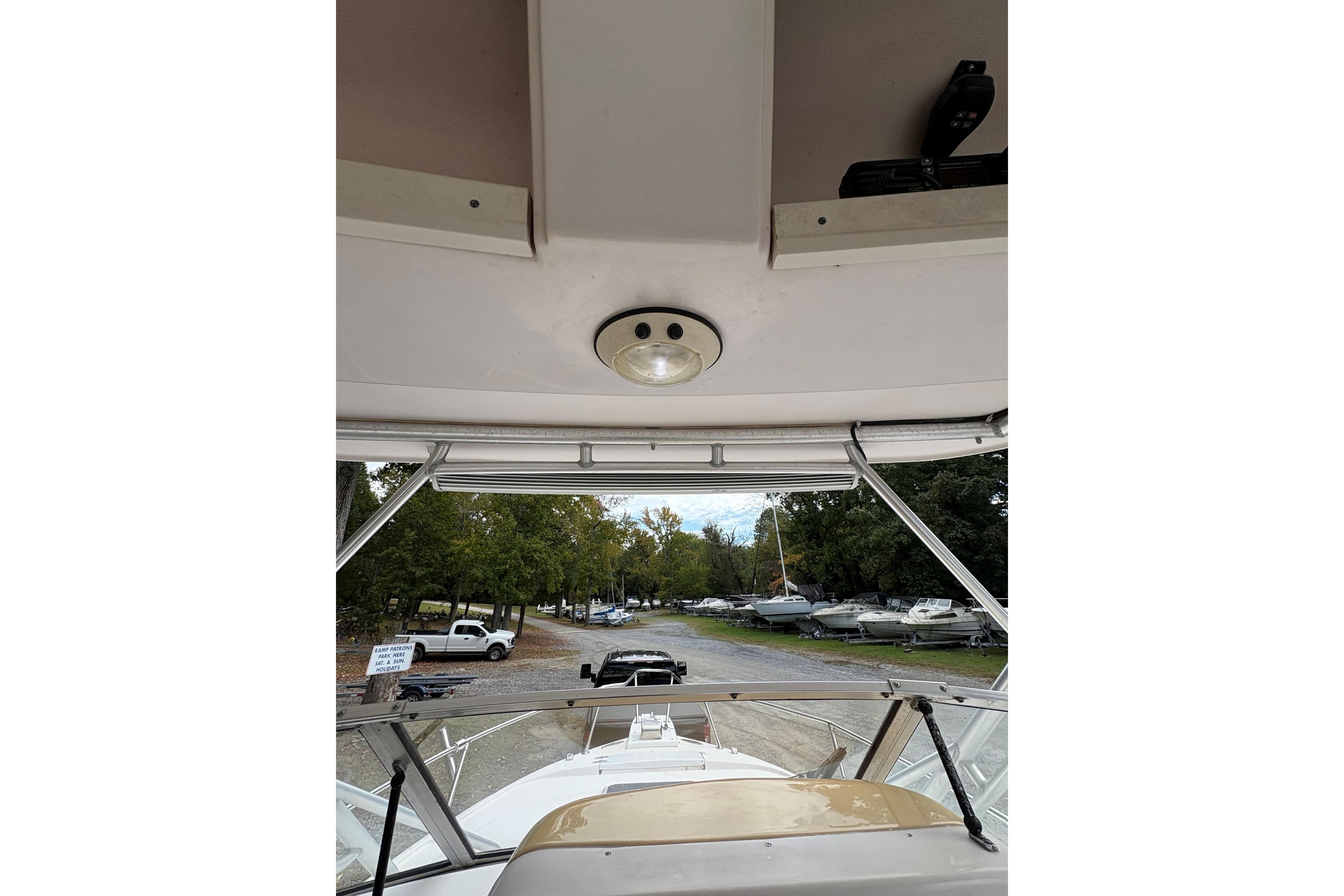 2001 Grady-White Express 265 boat interior view with overhead light and windshield.