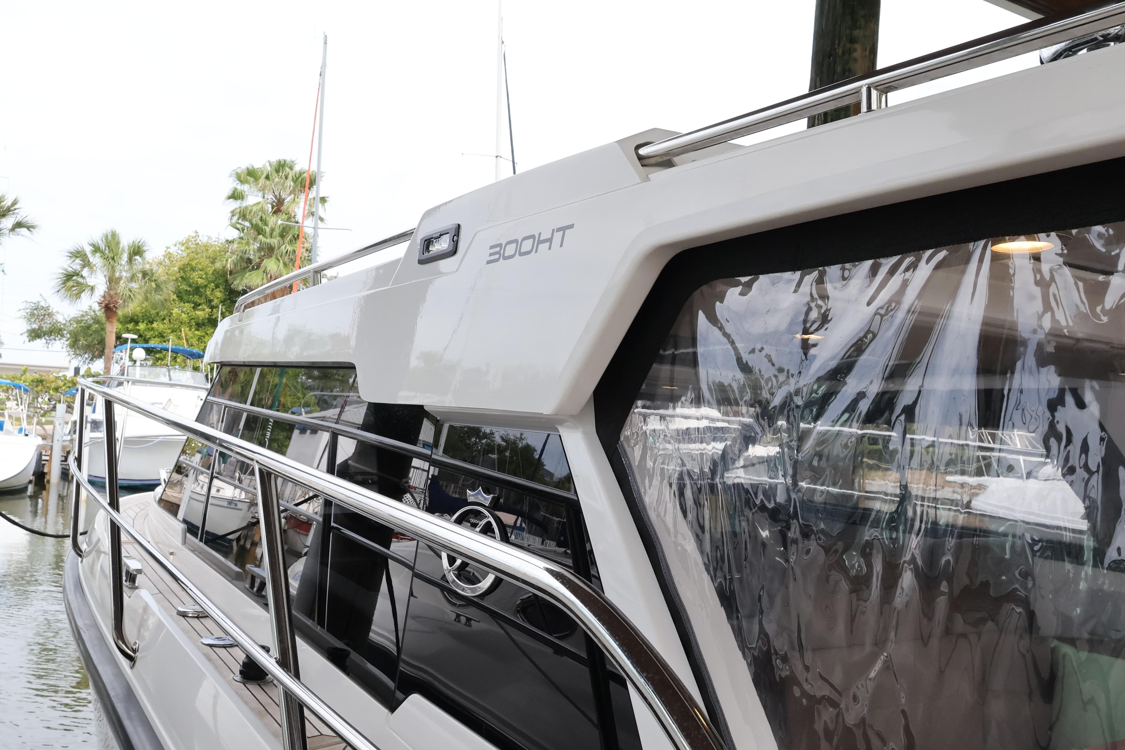 2024 Aquador 300 HT yacht docked, showcasing sleek design and modern features.