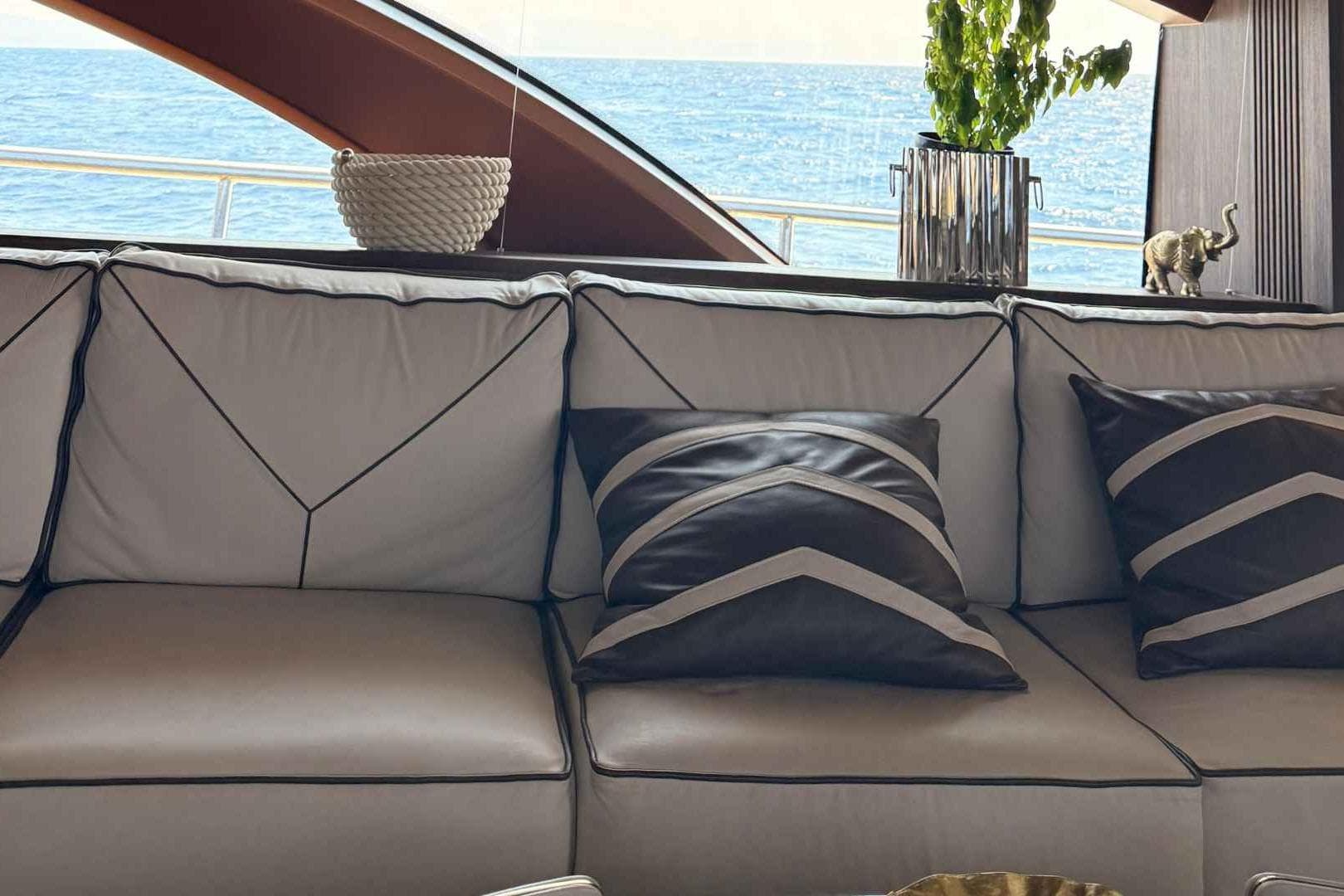 Luxurious interior of 2011 Azimut Fly 78 yacht with elegant cushions and ocean view.