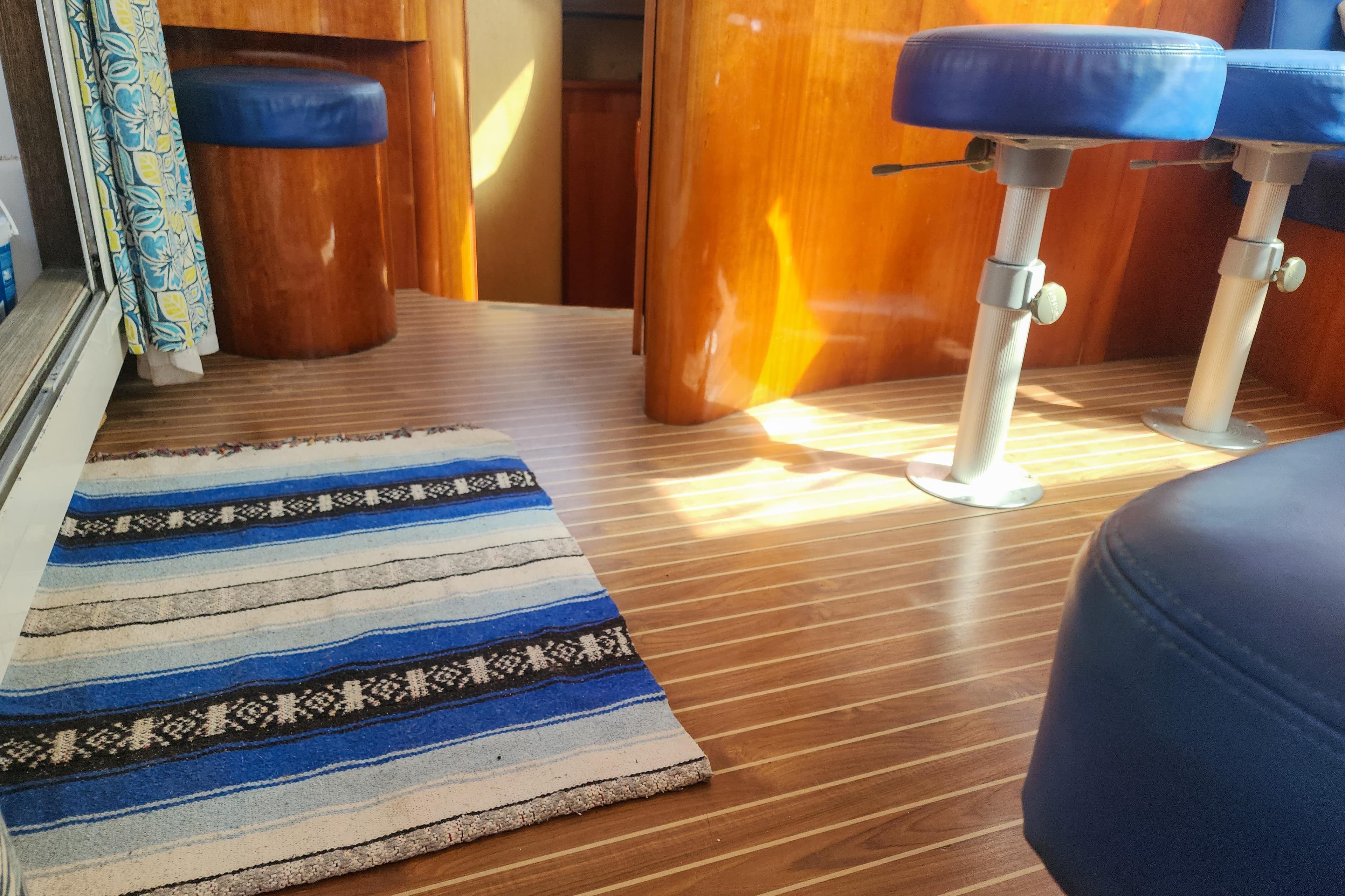 Interior of 2001 Privilege 435 yacht with wooden flooring and blue seating.