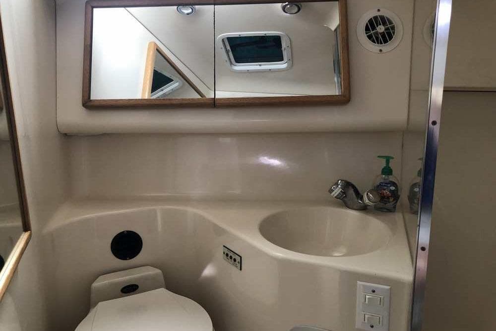 Bathroom interior of 1996 Sea Ray Sundancer 370 yacht with sink and mirror.