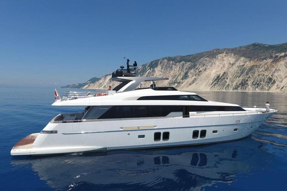 Sanlorenzo SL96 2016 yacht cruising near rocky coastline.