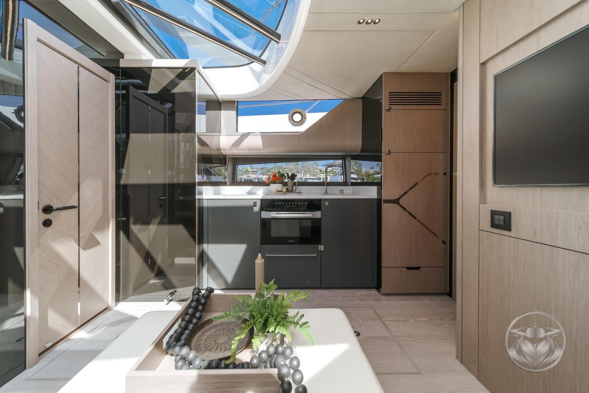 Luxurious interior of 2026 Sunseeker Superhawk 55 yacht, featuring modern kitchen and elegant design.