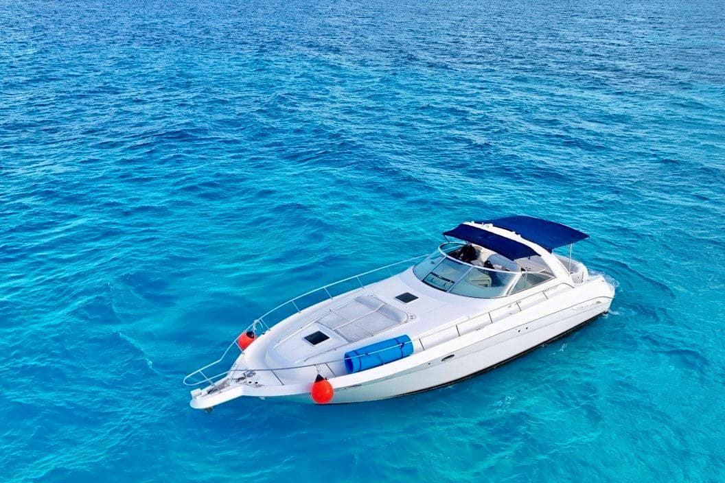 2000 Searay 460 Sundancer yacht cruising on clear blue ocean waters.