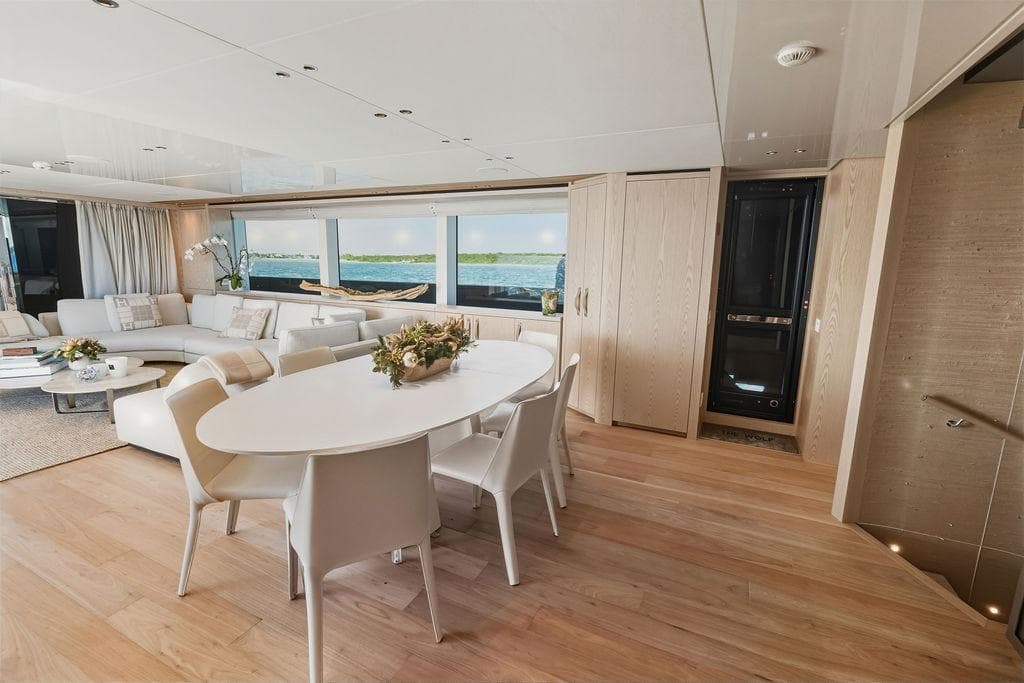 Luxurious interior of 2023 Sanlorenzo SD118 yacht with elegant dining and seating area.