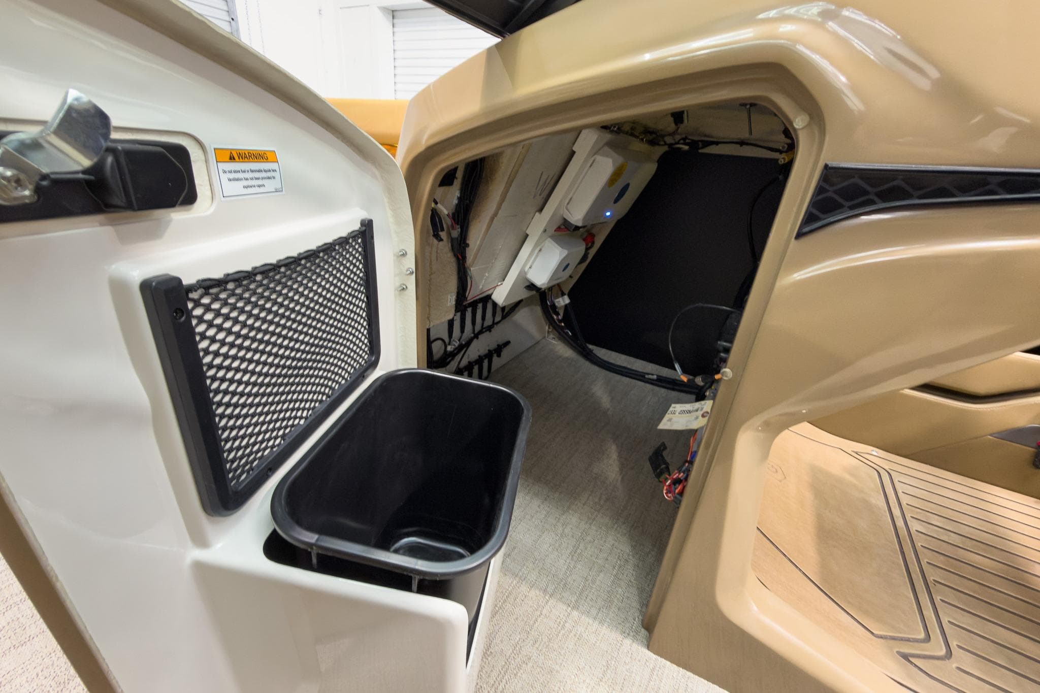 Interior view of 2026 Godfrey Sanpan 27' Tritoon, featuring storage and wiring access.