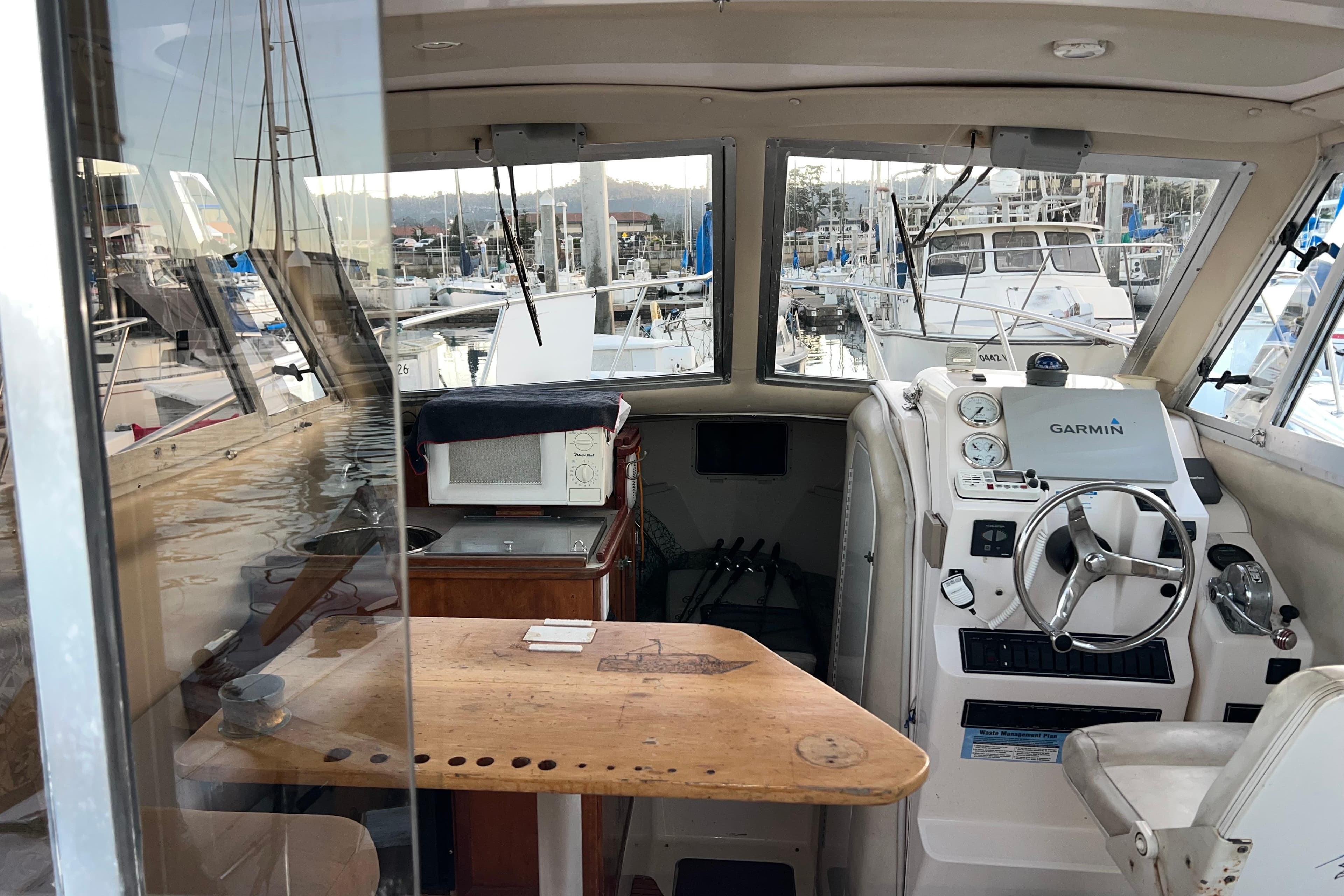 Interior of a 2005 Shamrock 270 Mackinaw boat with steering wheel and navigation equipment.
